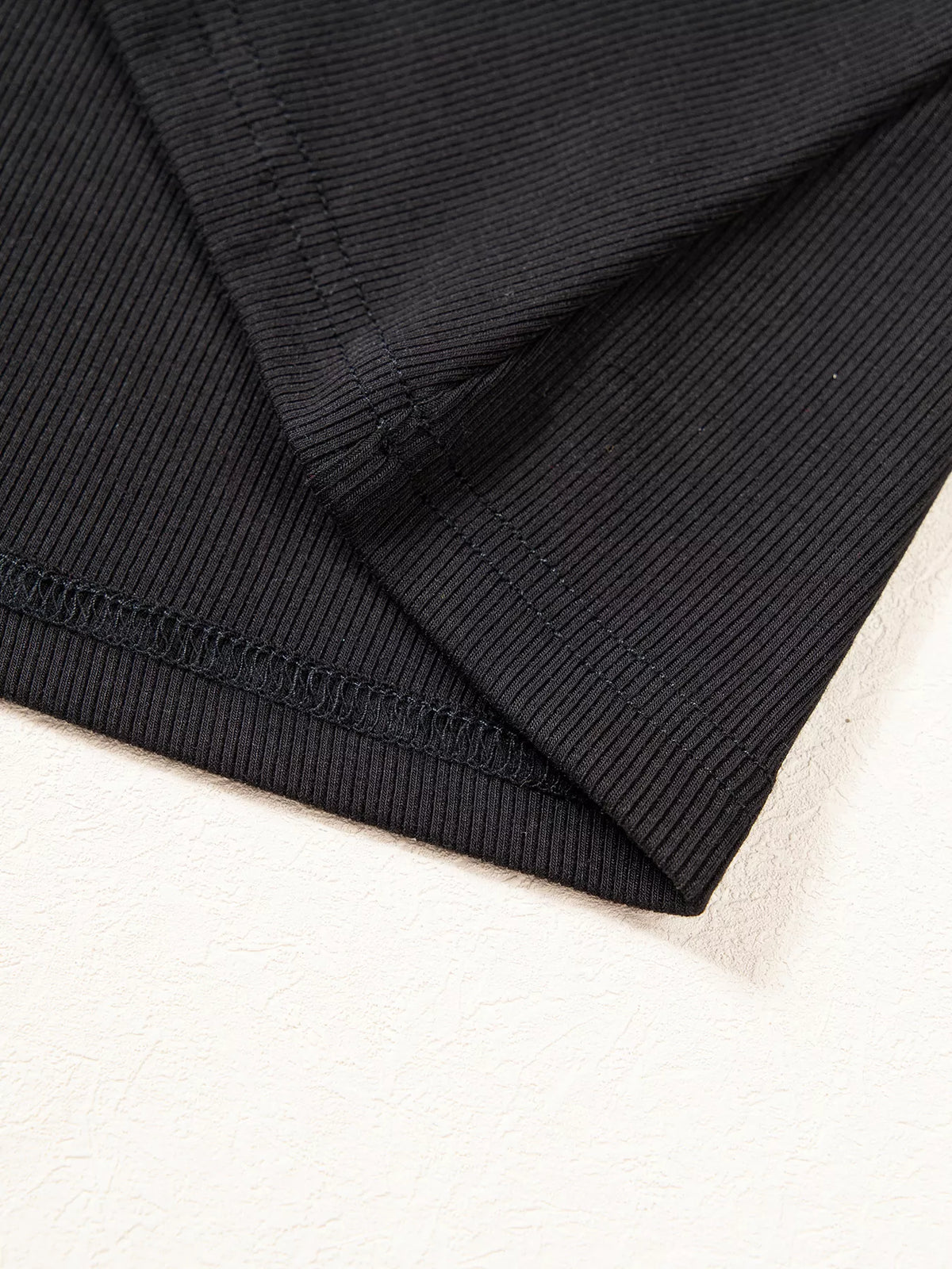 Hem stitching on black round neck frill detail long sleeve top