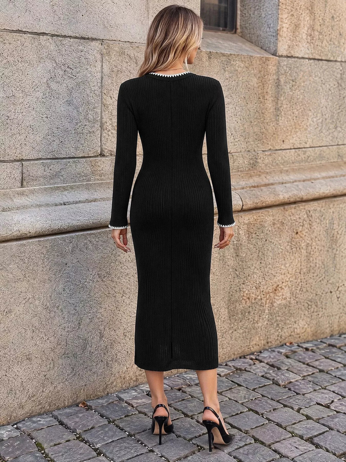 Black ribbed knit dress with white contrast trim, back view