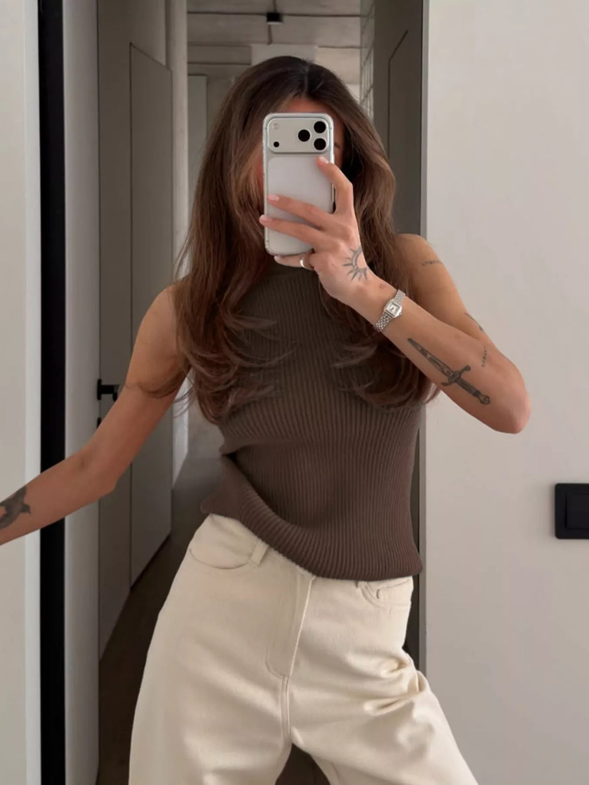 Brown ribbed halter-neck tank, front mirror view with arm out