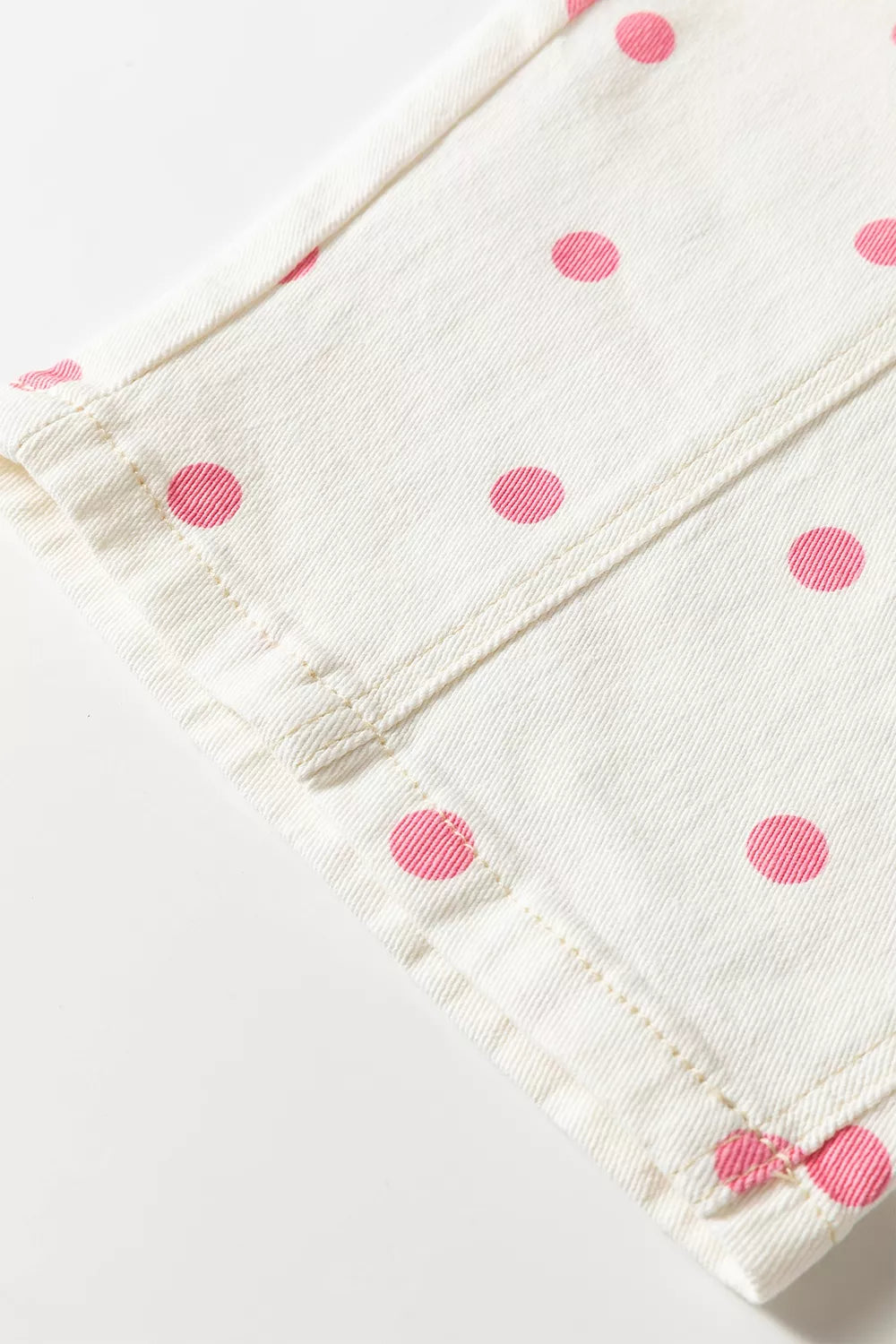 White with pink dots polka-dot cropped jeans, hem and seam close-up