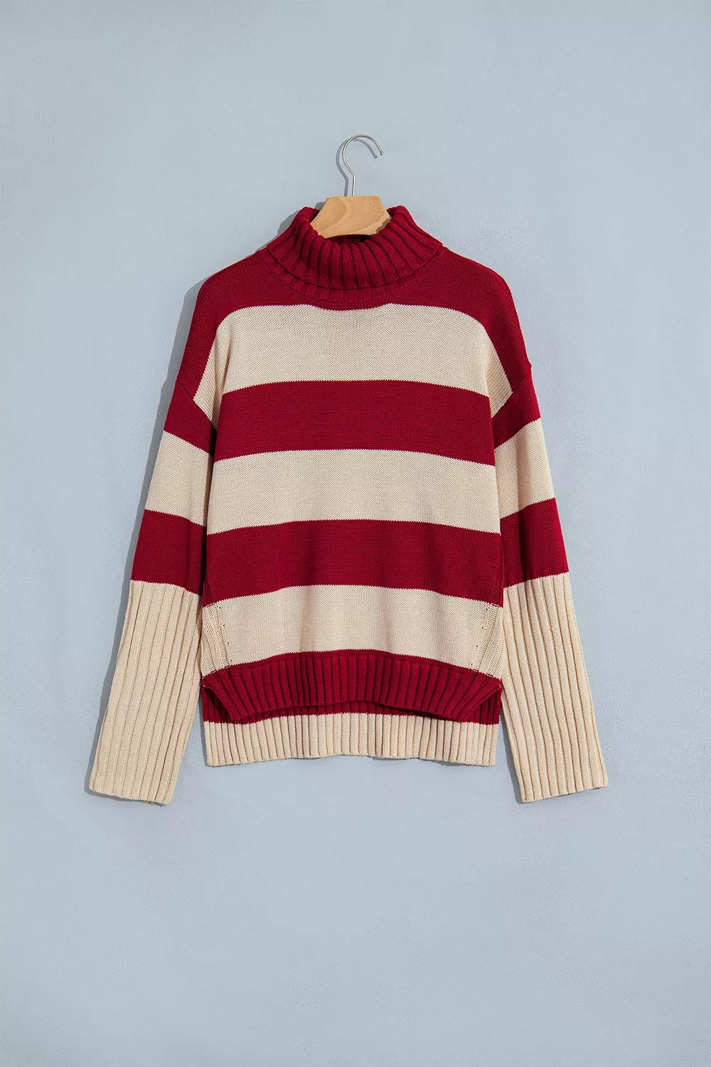 Striped High Neck Ribbed Trim Sweater in red and cream, front on hanger view