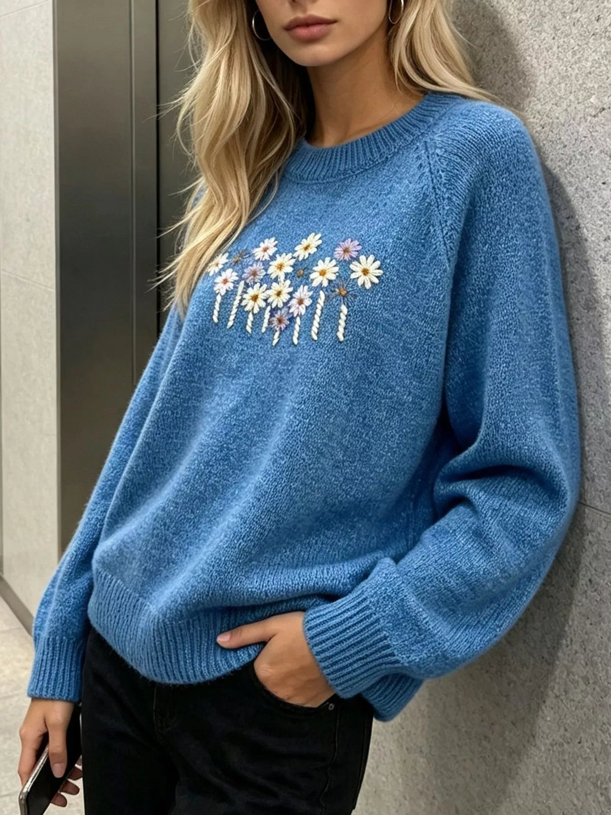 Floral embroidered round-neck sweater in blue, angled front view