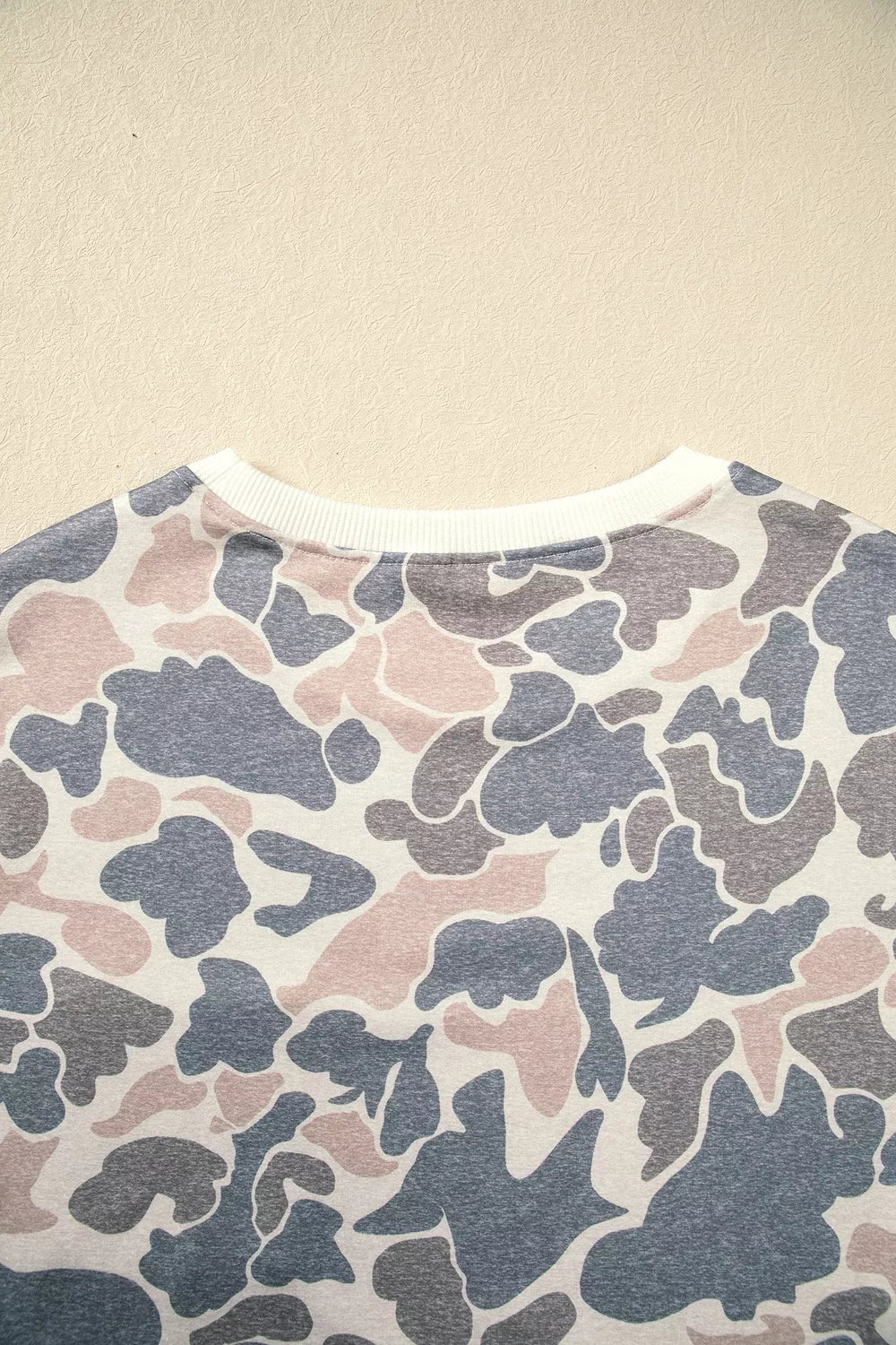 Gray and beige botanical camo mini dress with white ribbed cuffs and side pockets, back neckline detail