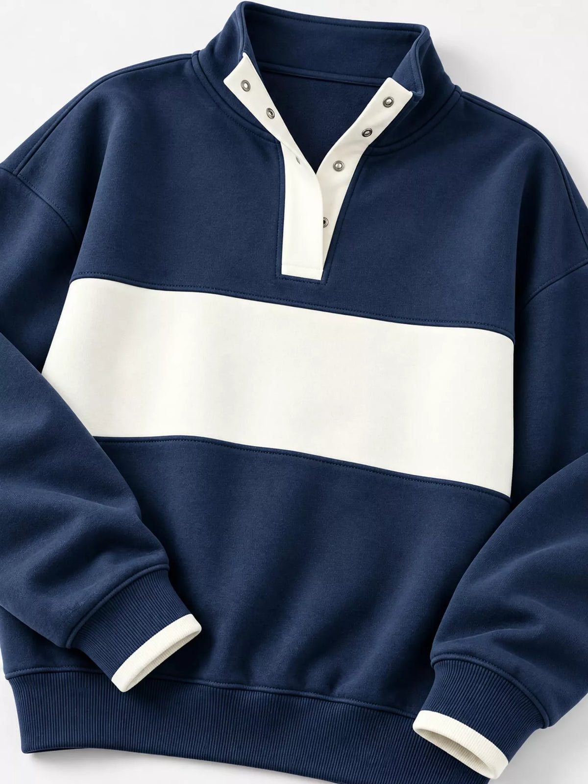 Navy and cream color block snap-button sweatshirt, snap neckline, contrast chest panel, cuffs, and hem