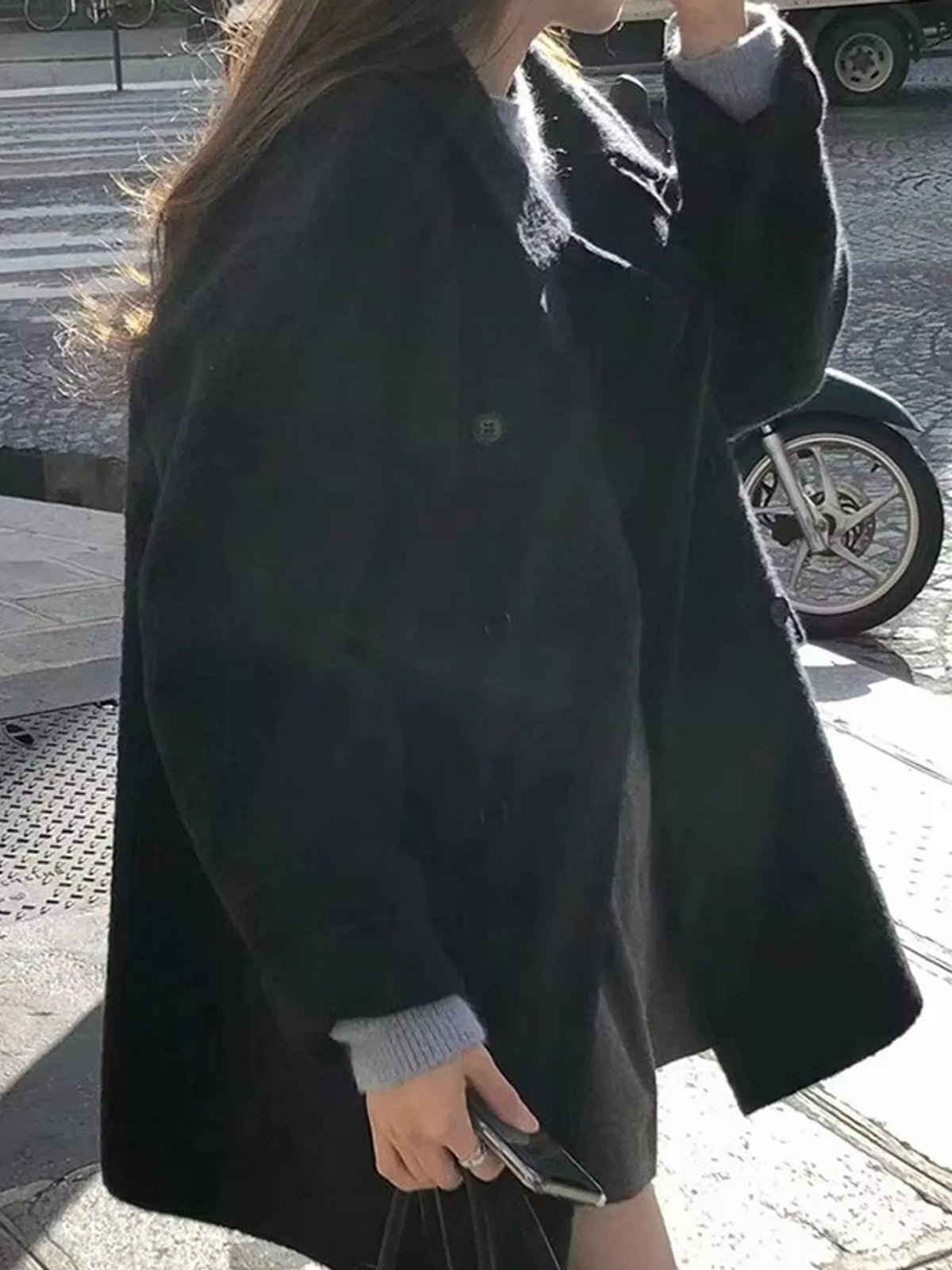 Black double-breasted wool-blend coat — side view