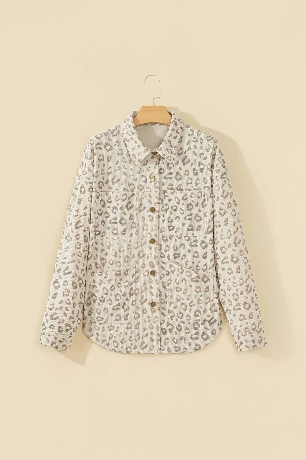 Beige leopard corduroy button-front jacket, front on hanger.