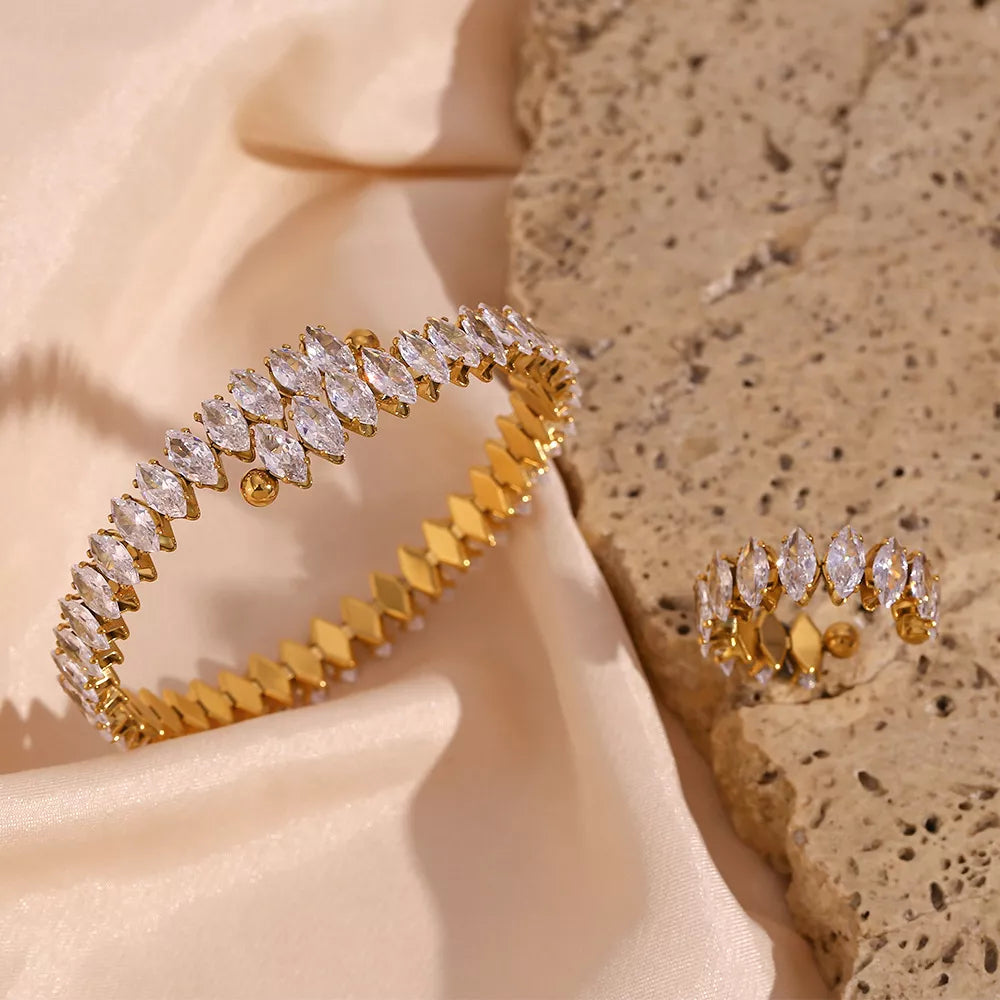 Gold-plated zircon bracelet and ring set — bracelet and ring on fabric and stone