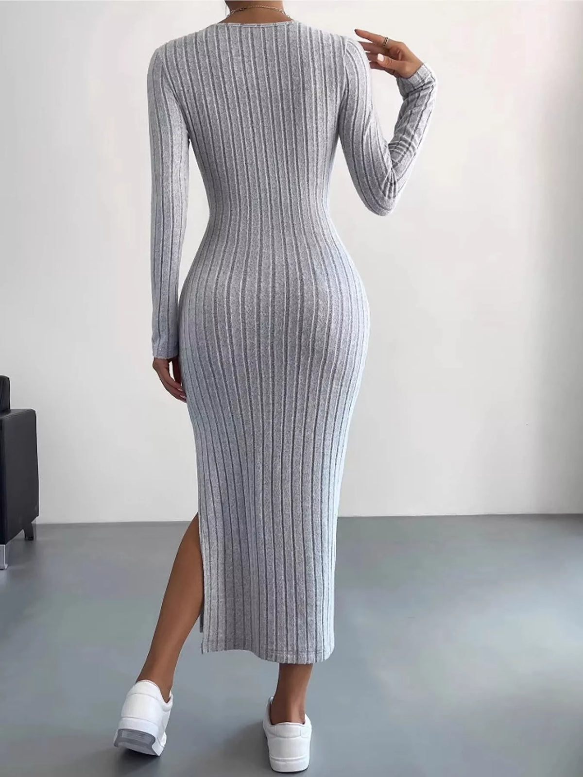 Light gray ribbed long sleeve knit dress with side slit, back view