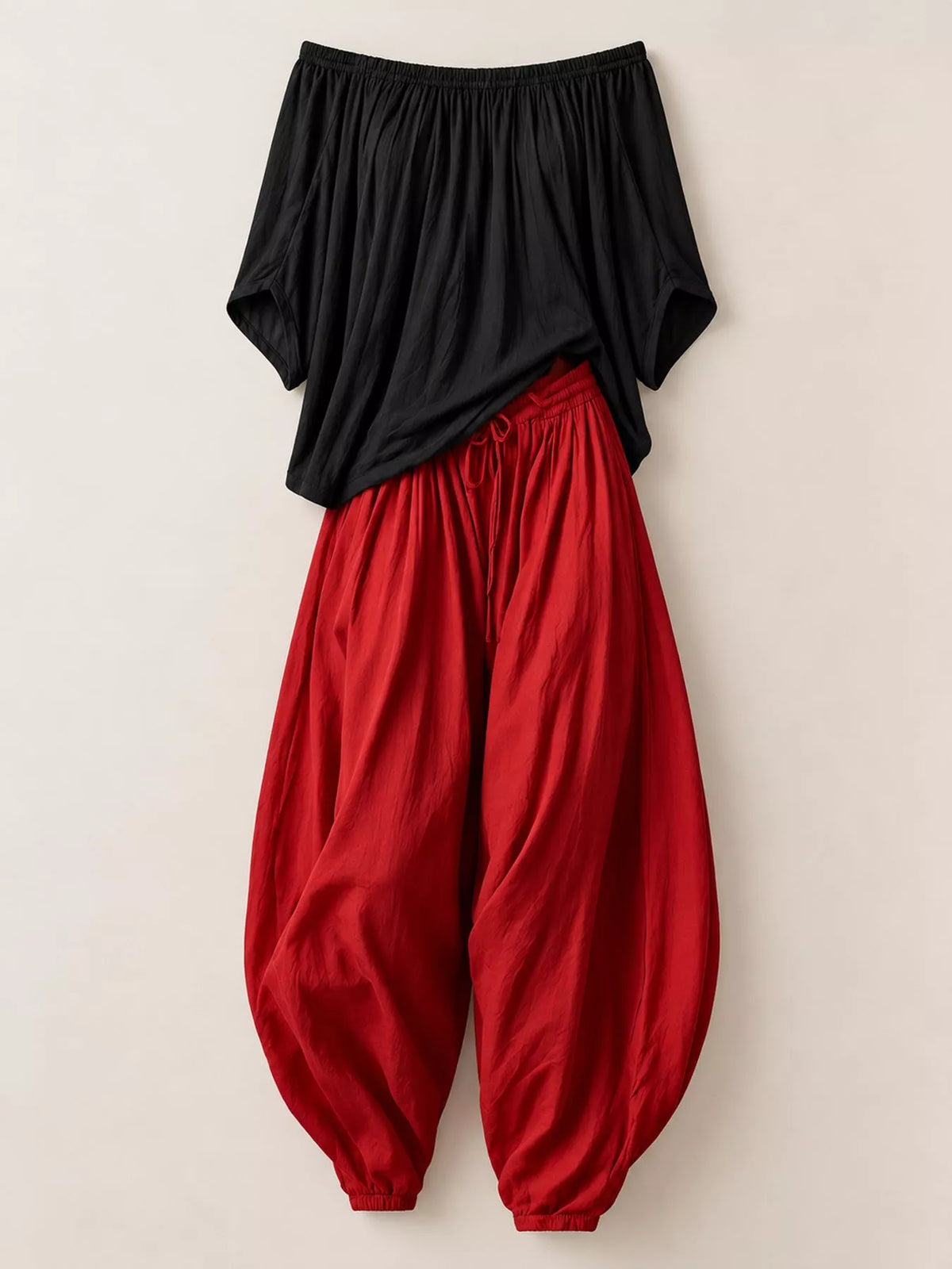 Black top and red pants off-shoulder top and wide-leg harem pants set — front view