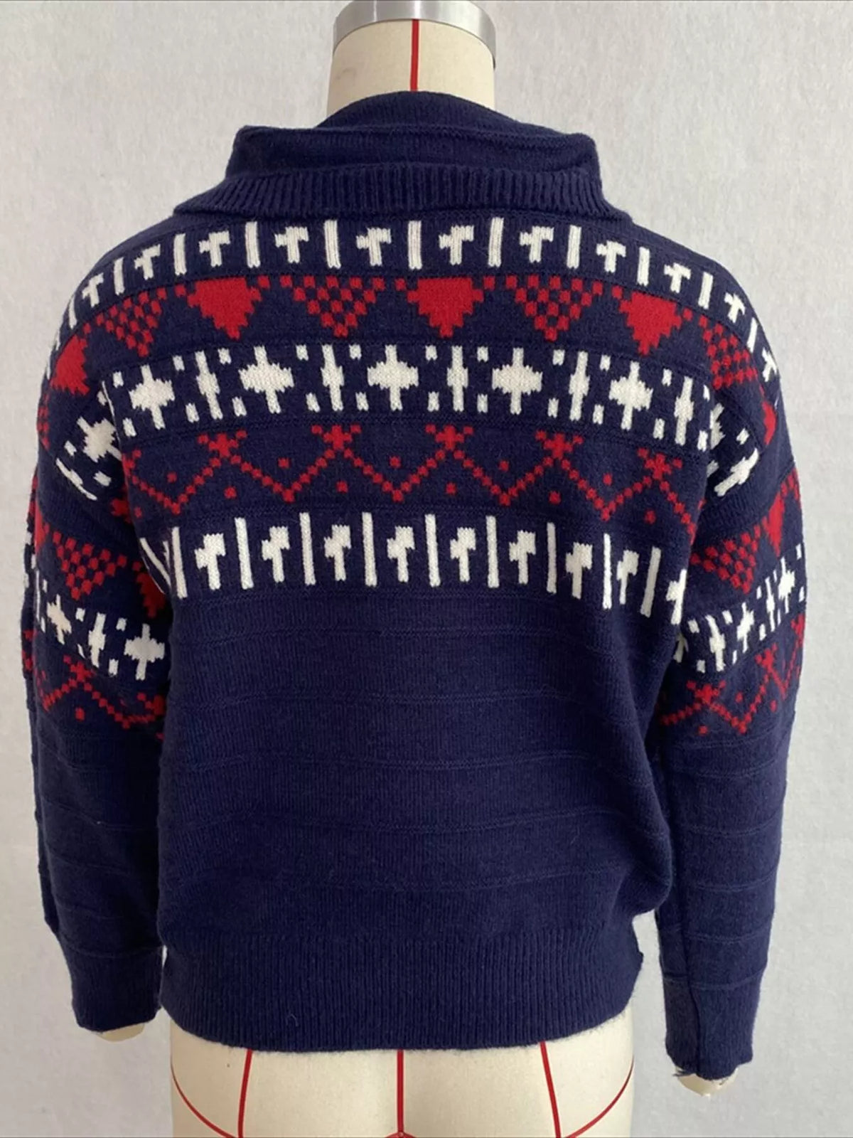 Navy fair isle polo-collar sweater, back on dress form.