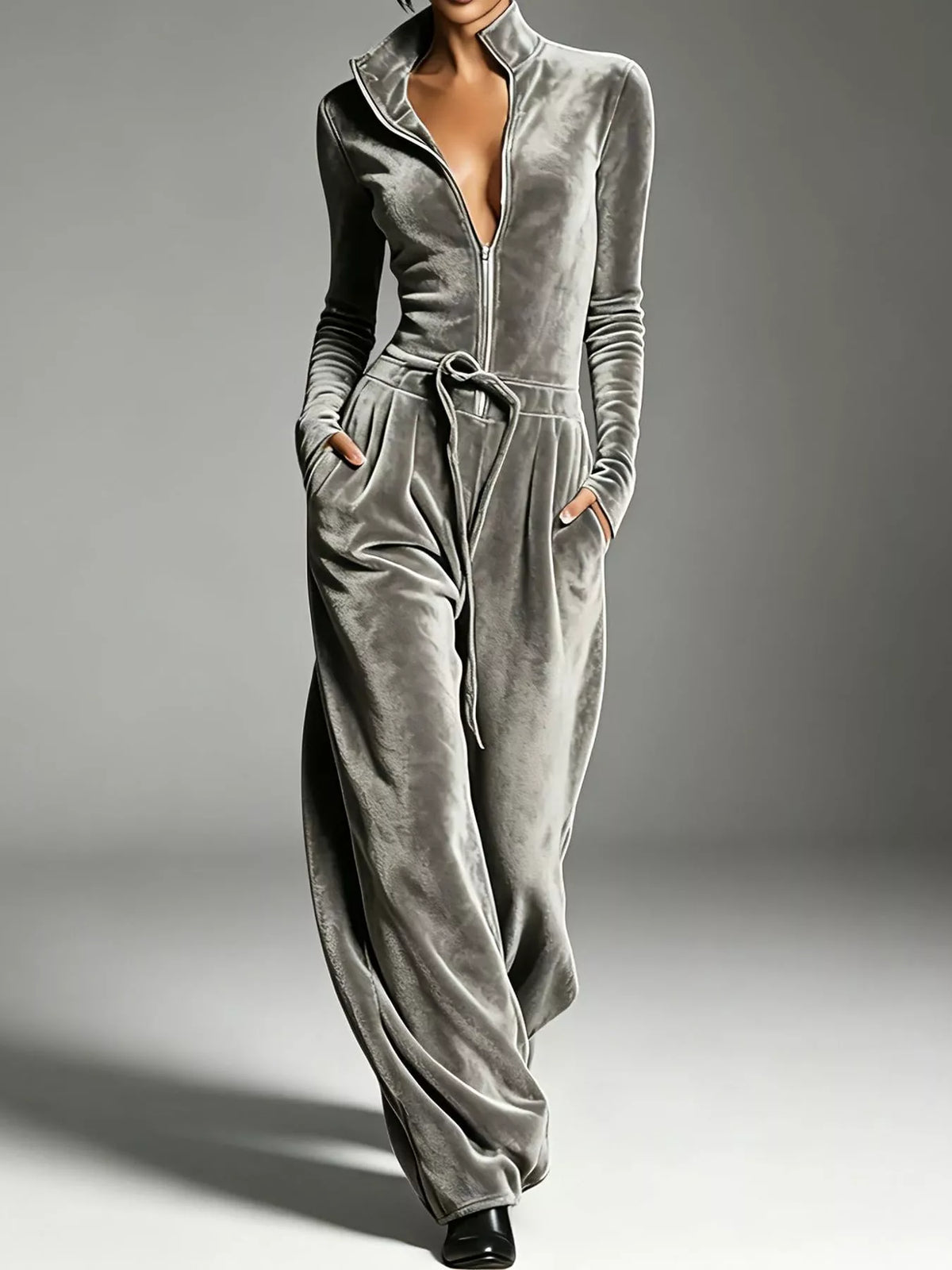 Gray velvet zip up jumpsuit with tie waist, front view