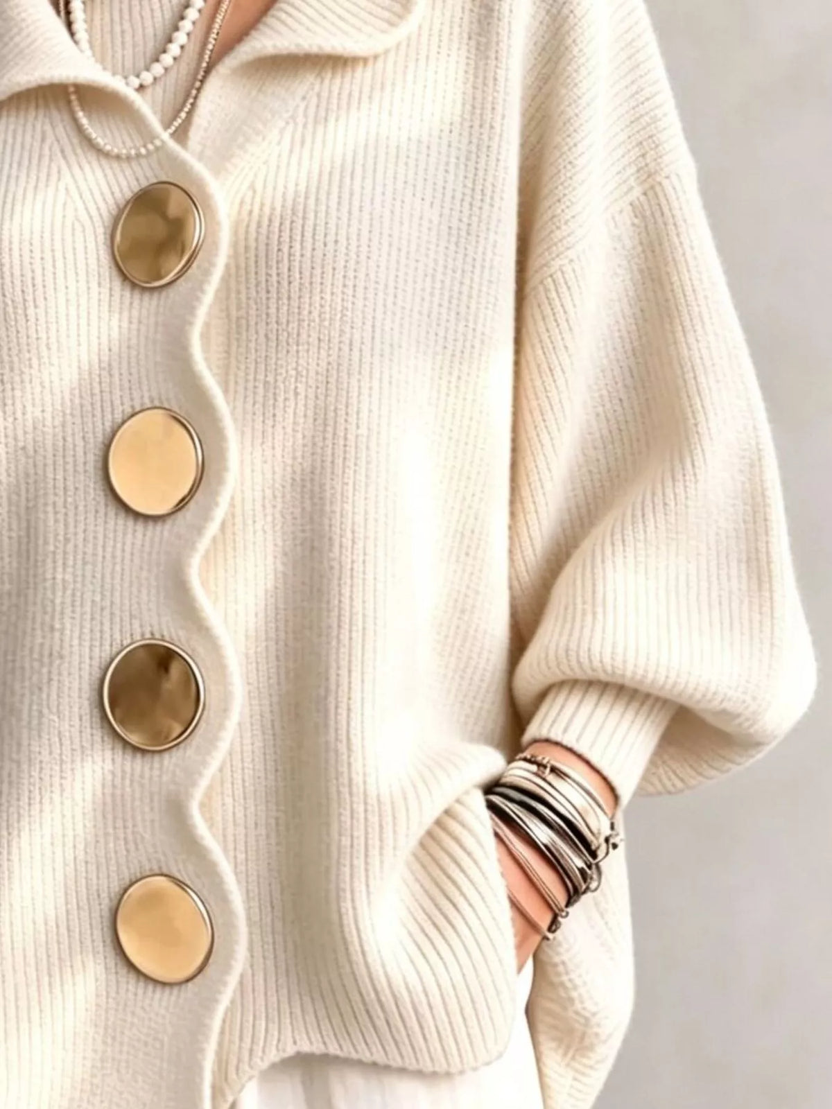 Beige scalloped-edge knit cardigan, cuff and button detail