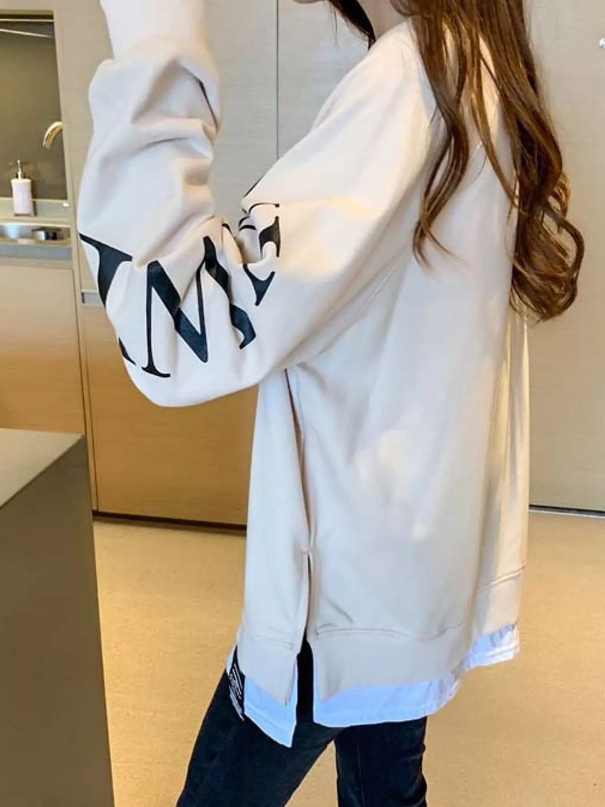Apricot layered-hem sweatshirt with graphic sleeve detail