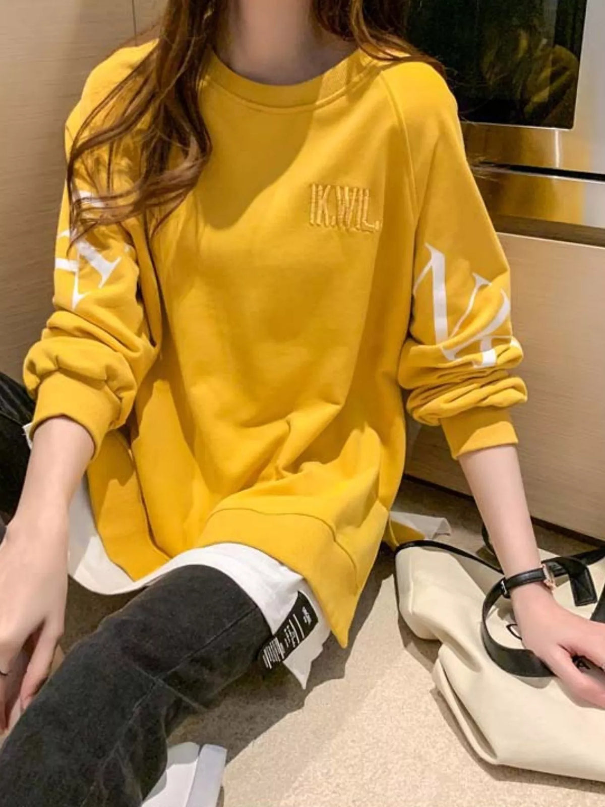 Yellow layered-hem sweatshirt with graphic sleeve detail