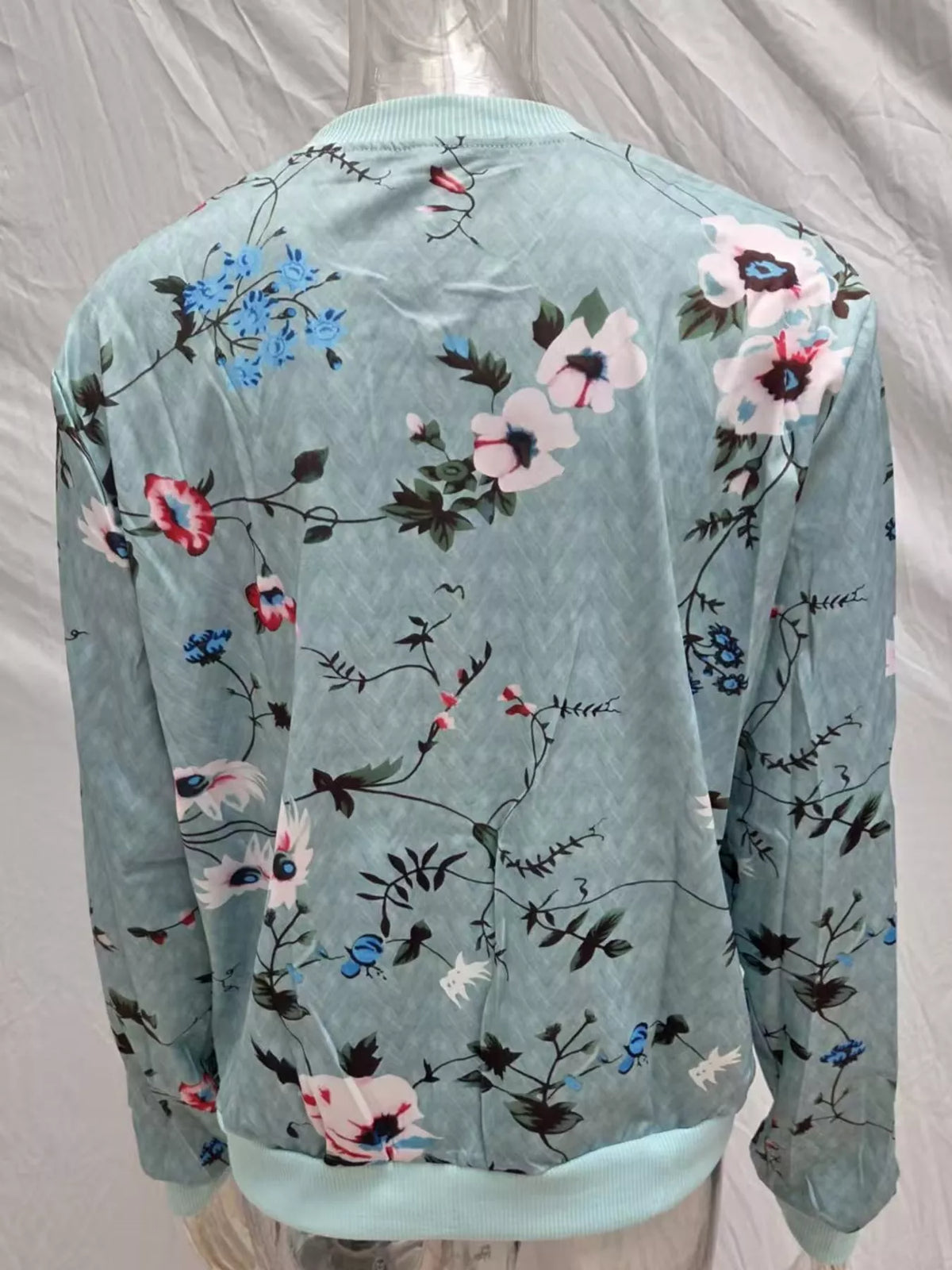 Light blue floral printed zip-up bomber jacket — back view