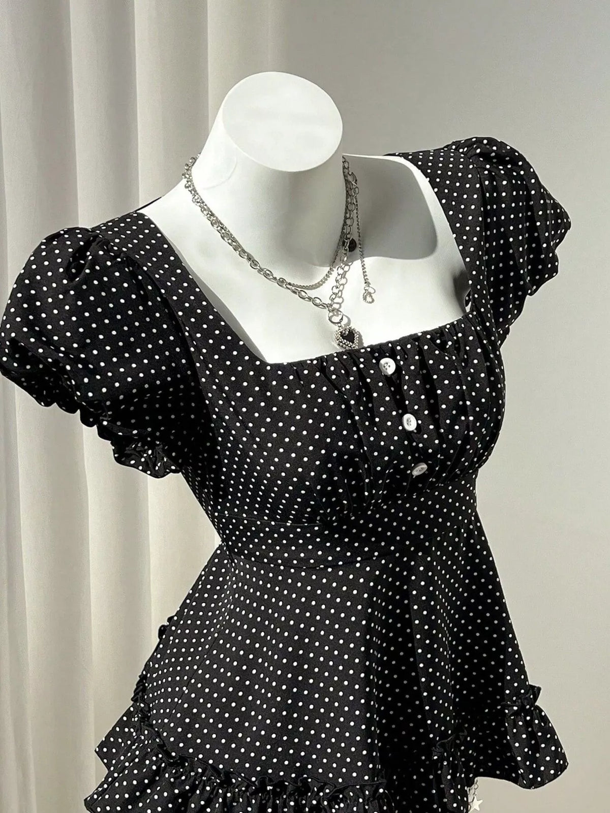 Polka-dot peplum blouse, black mannequin side