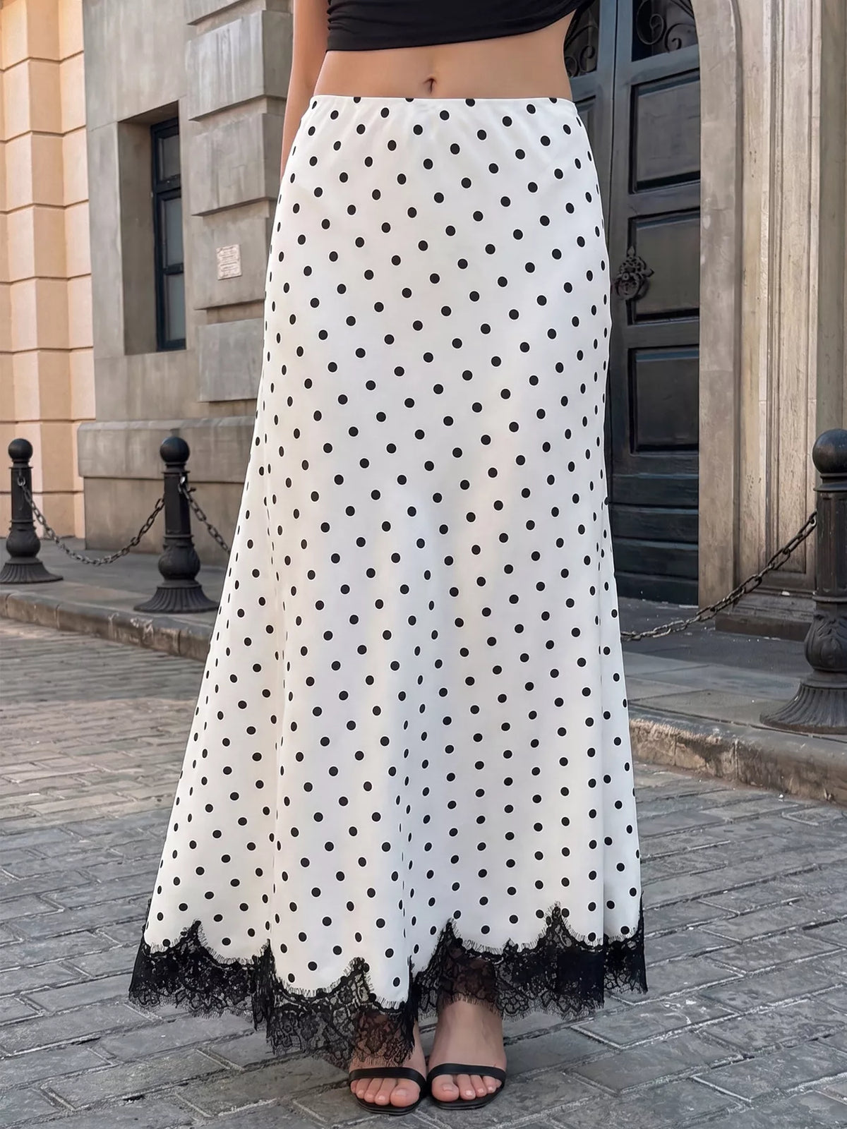 White and black polka dot high-waisted maxi skirt with black lace hem