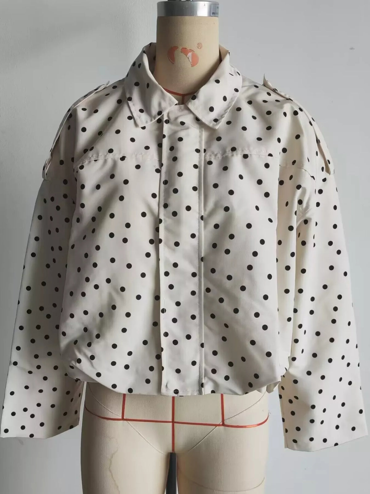 Cream polka dot zip-up jacket — front view