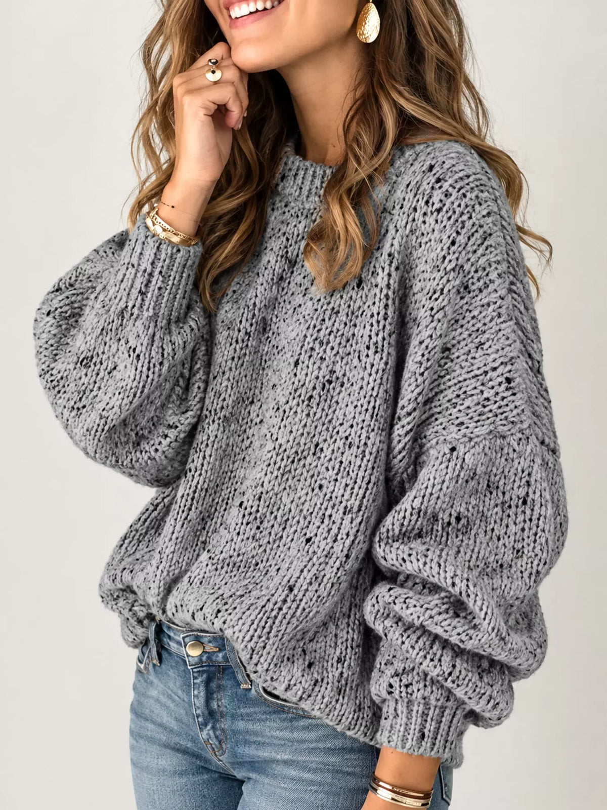 Gray chunky knit round neck sweater, side view