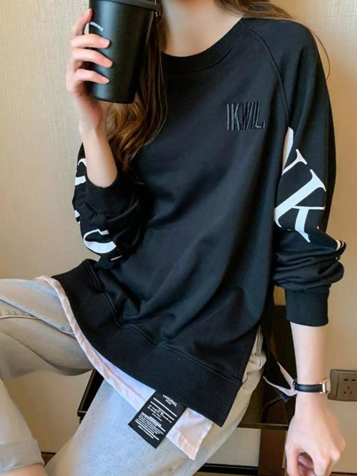 Black layered-hem sweatshirt with graphic sleeve detail