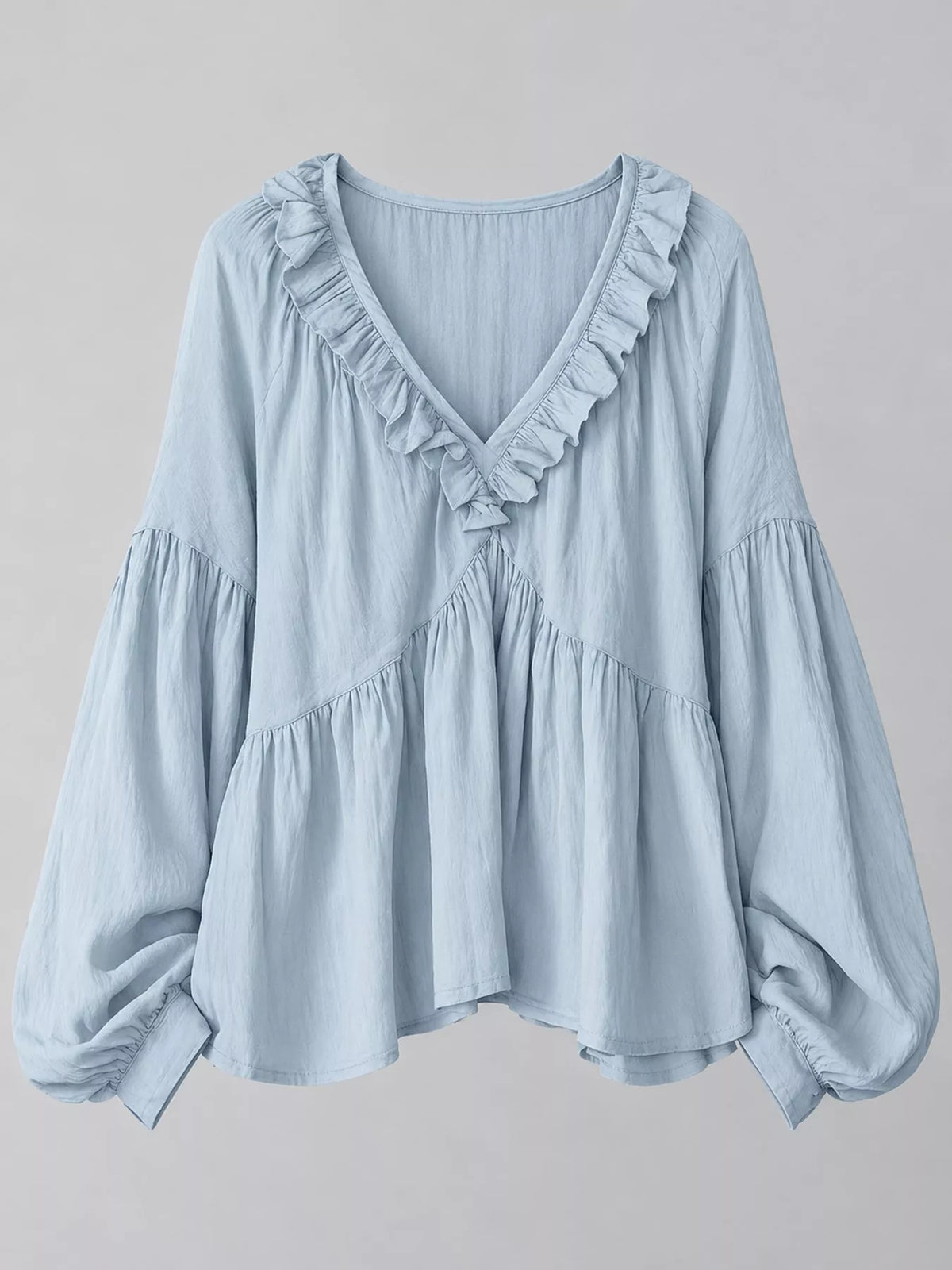 Light blue ruffled v neck blouse, front view