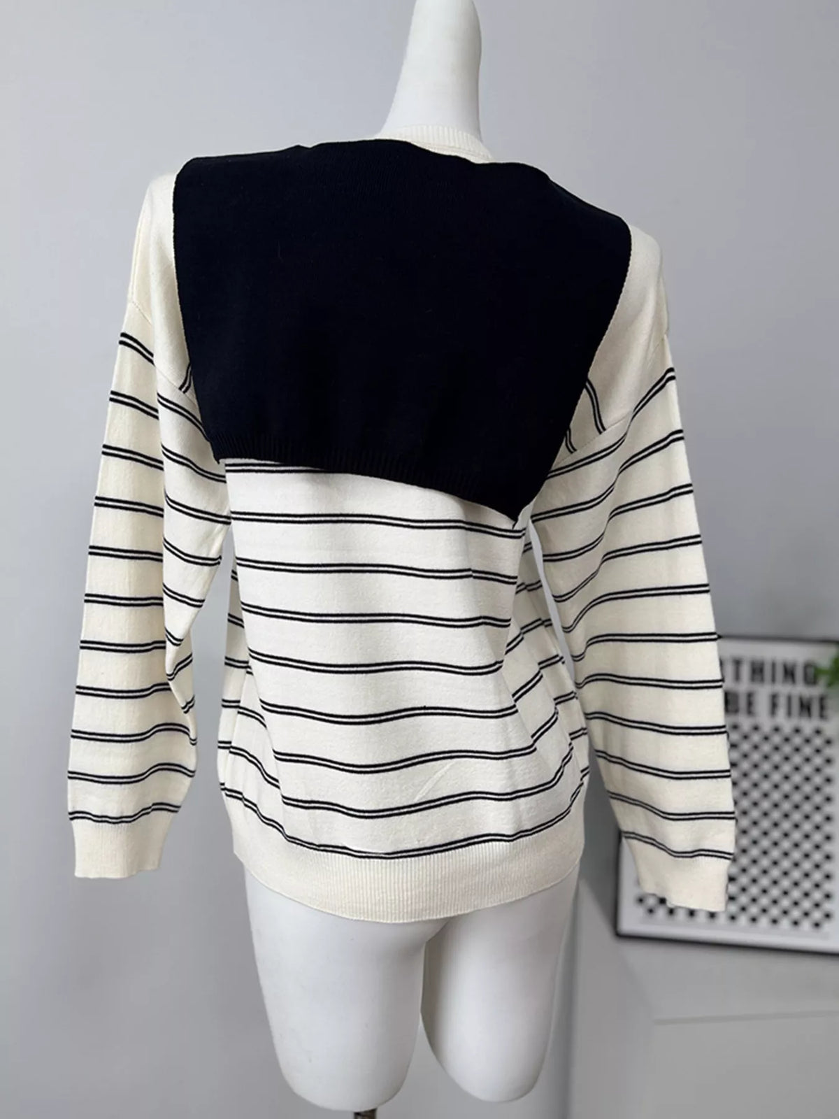 Striped crewneck sweater with layered tie detail in white and black, back with shoulder layer