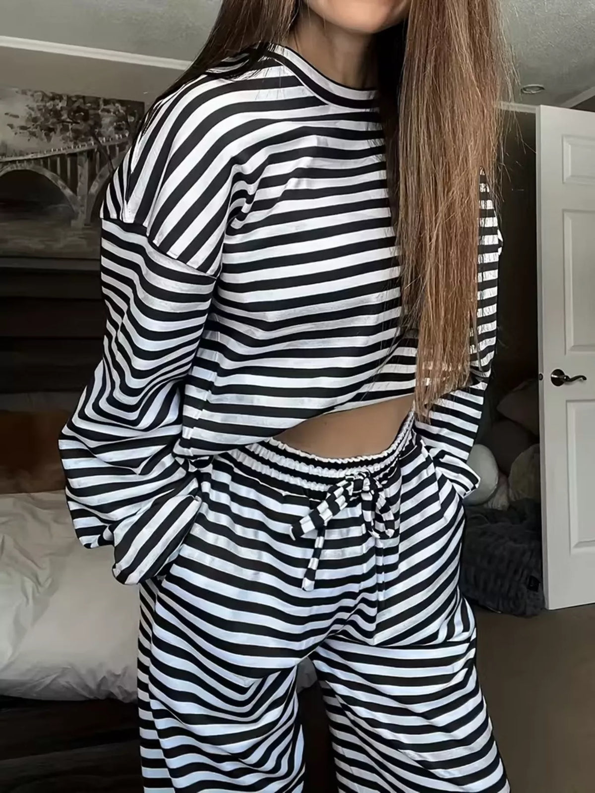 Black striped long-sleeve top and pants set, top and waistband detail