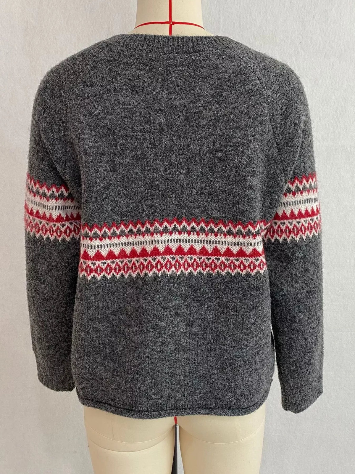 Charcoal geometric button-front knit cardigan, back on dress form.