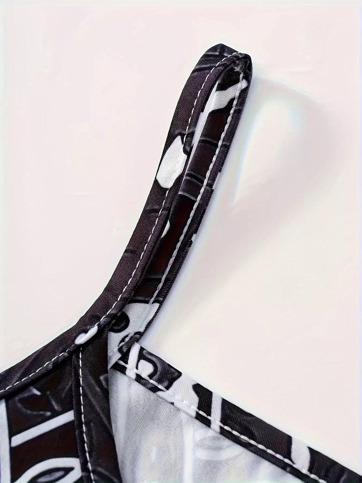 Black and white printed spaghetti strap maxi dress, close-up of the adjustable shoulder strap