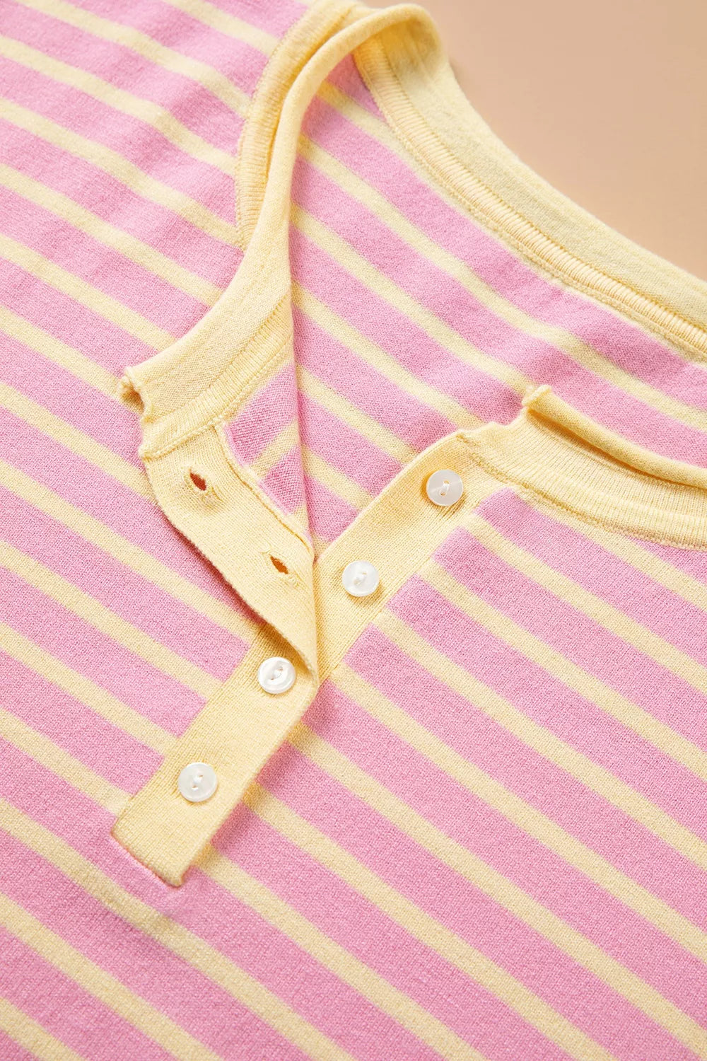Pink and yellow striped button-detail sweater, button placket detail