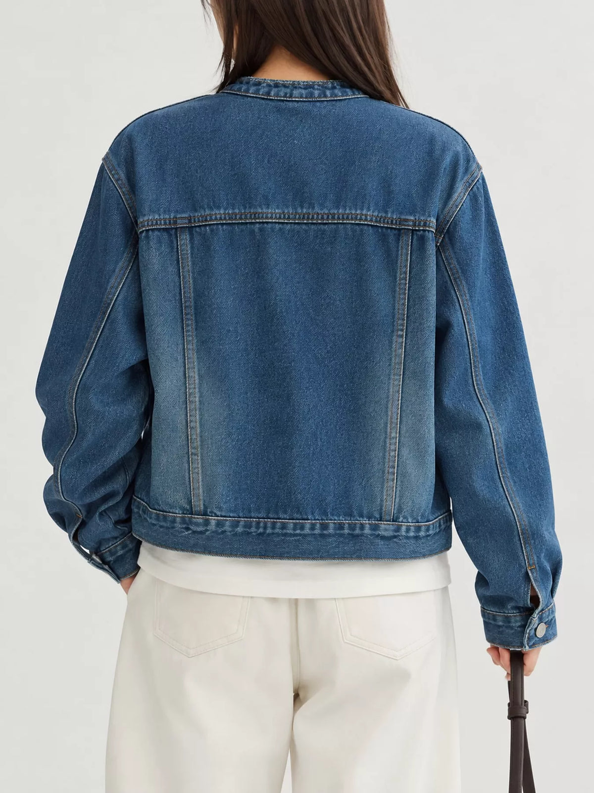 Blue button-up cropped denim jacket — back view