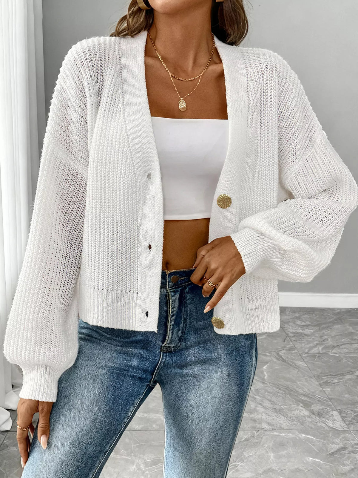 V-neck ribbed knit cardigan in white, standing front view