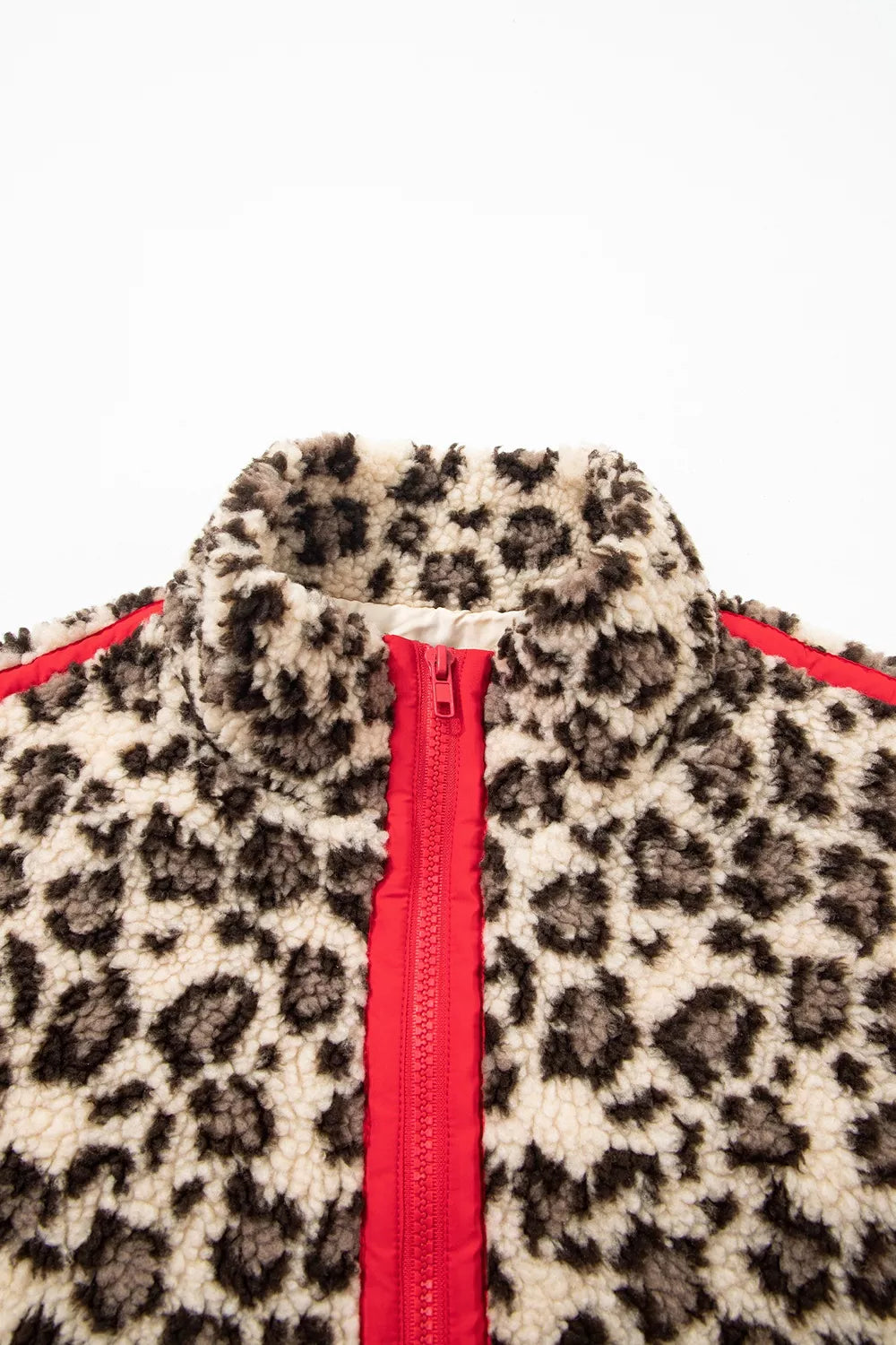 Leopard leopard half-zip sweatshirt with red trim, closed collar and zipper detail.
