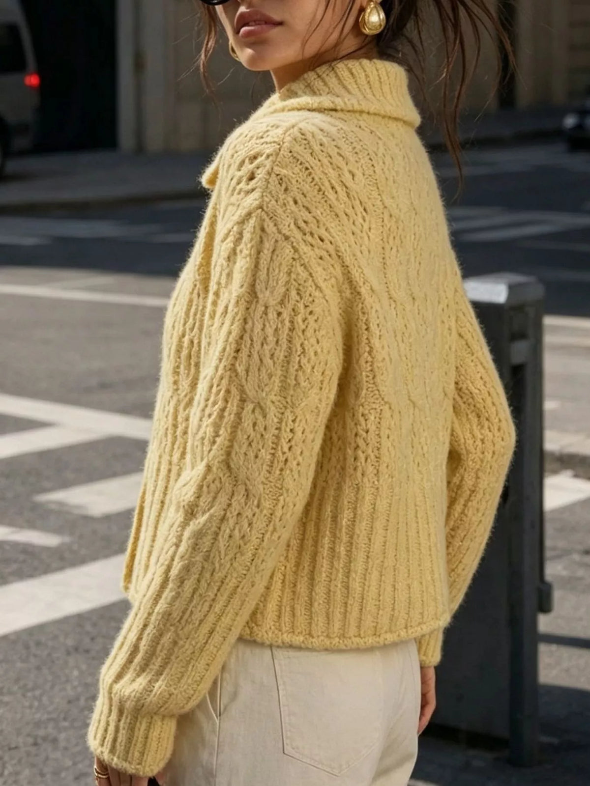 Yellow cable-knit collared button-front cardigan, back view.