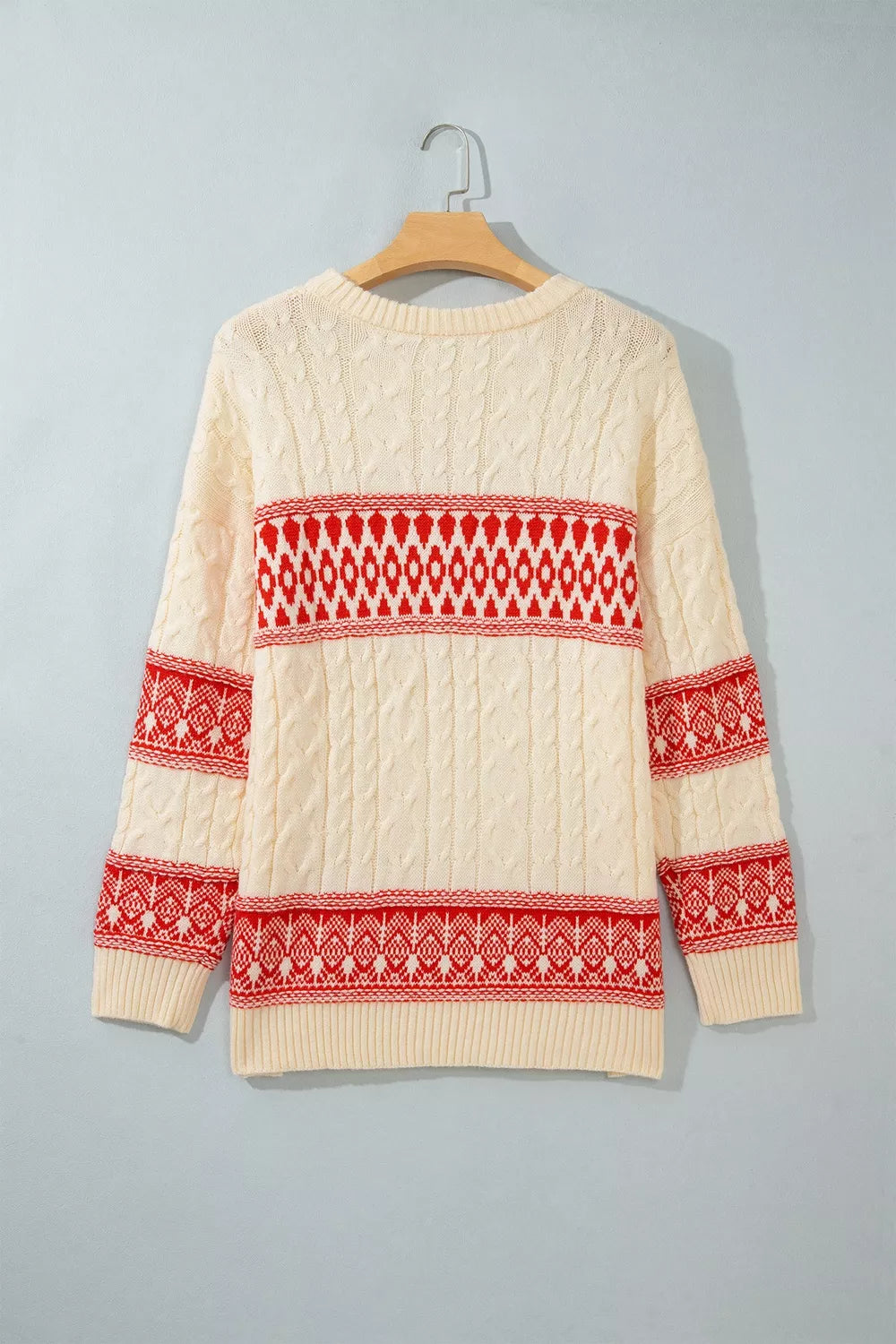 Ivory geometric cable-knit crewneck sweater, back on hanger.