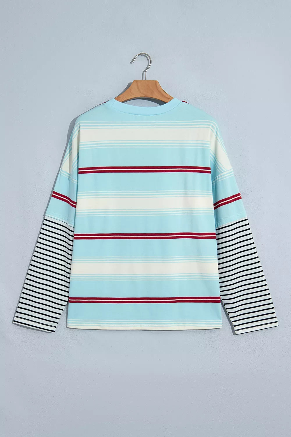 Striped Patchwork Long Sleeve Pullover Top in blue, hanger back view
