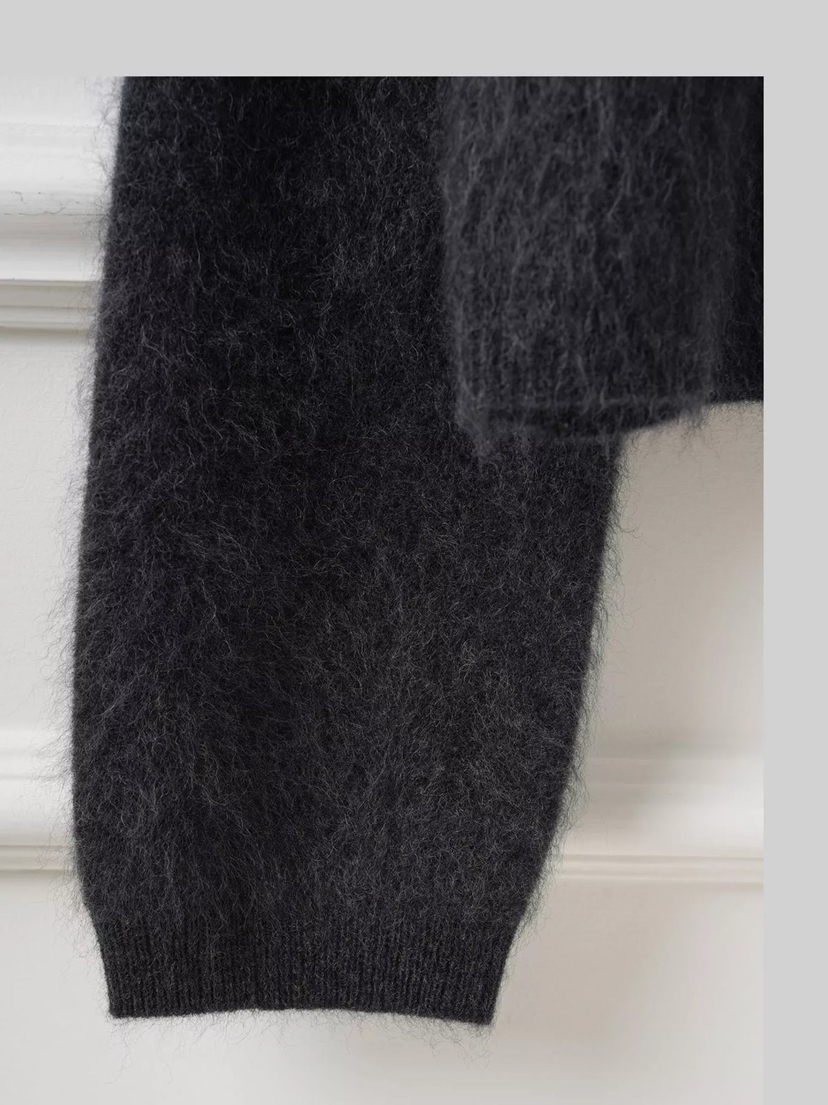 Black fuzzy button up cropped cardigan, detail view