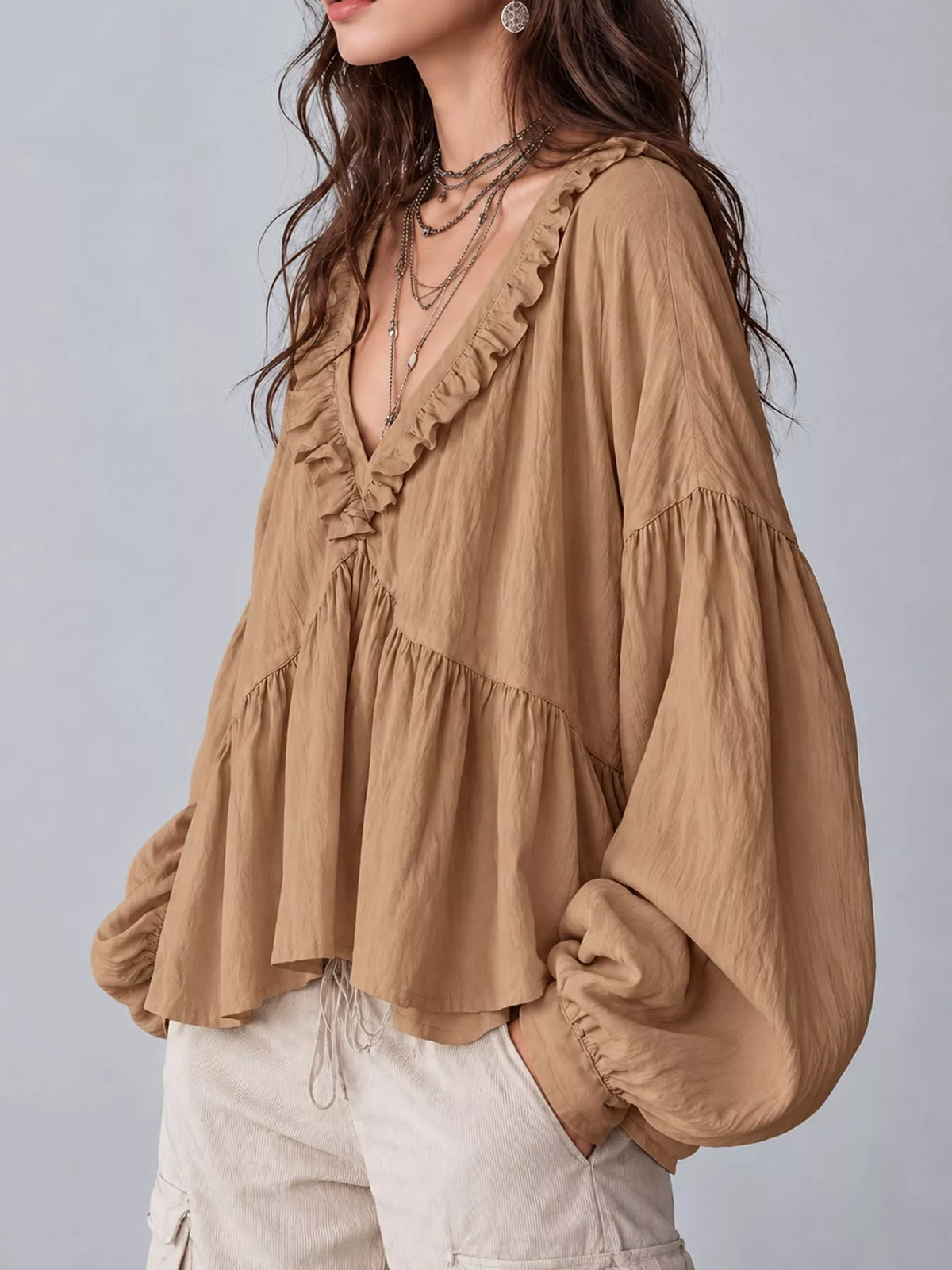 Tan ruffled v neck blouse, side view