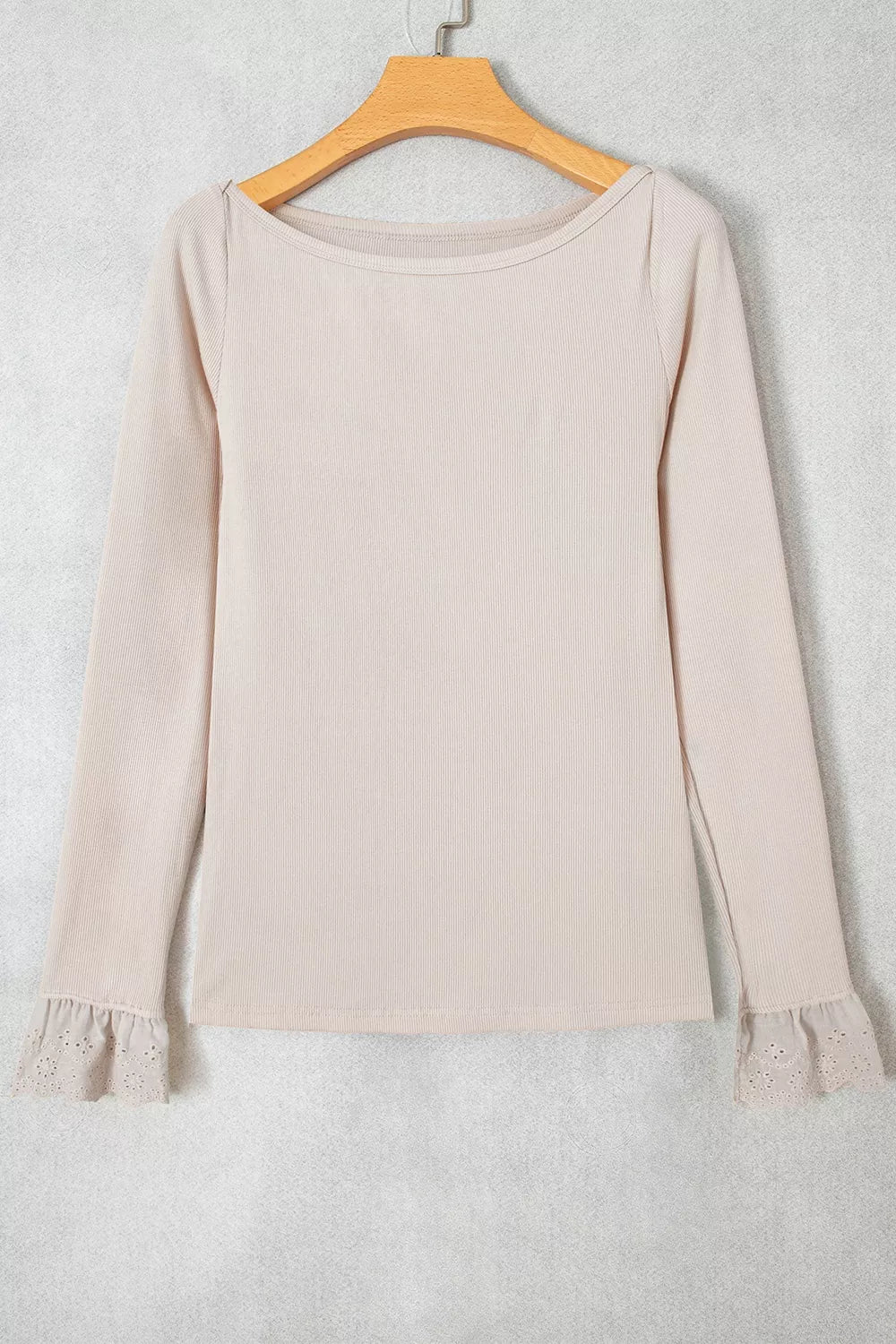 Beige lace-cuff long sleeve top, front on hanger