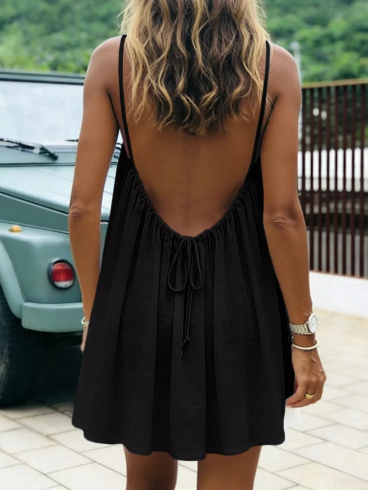 Black spaghetti strap A-line mini dress with open tie back, open back view