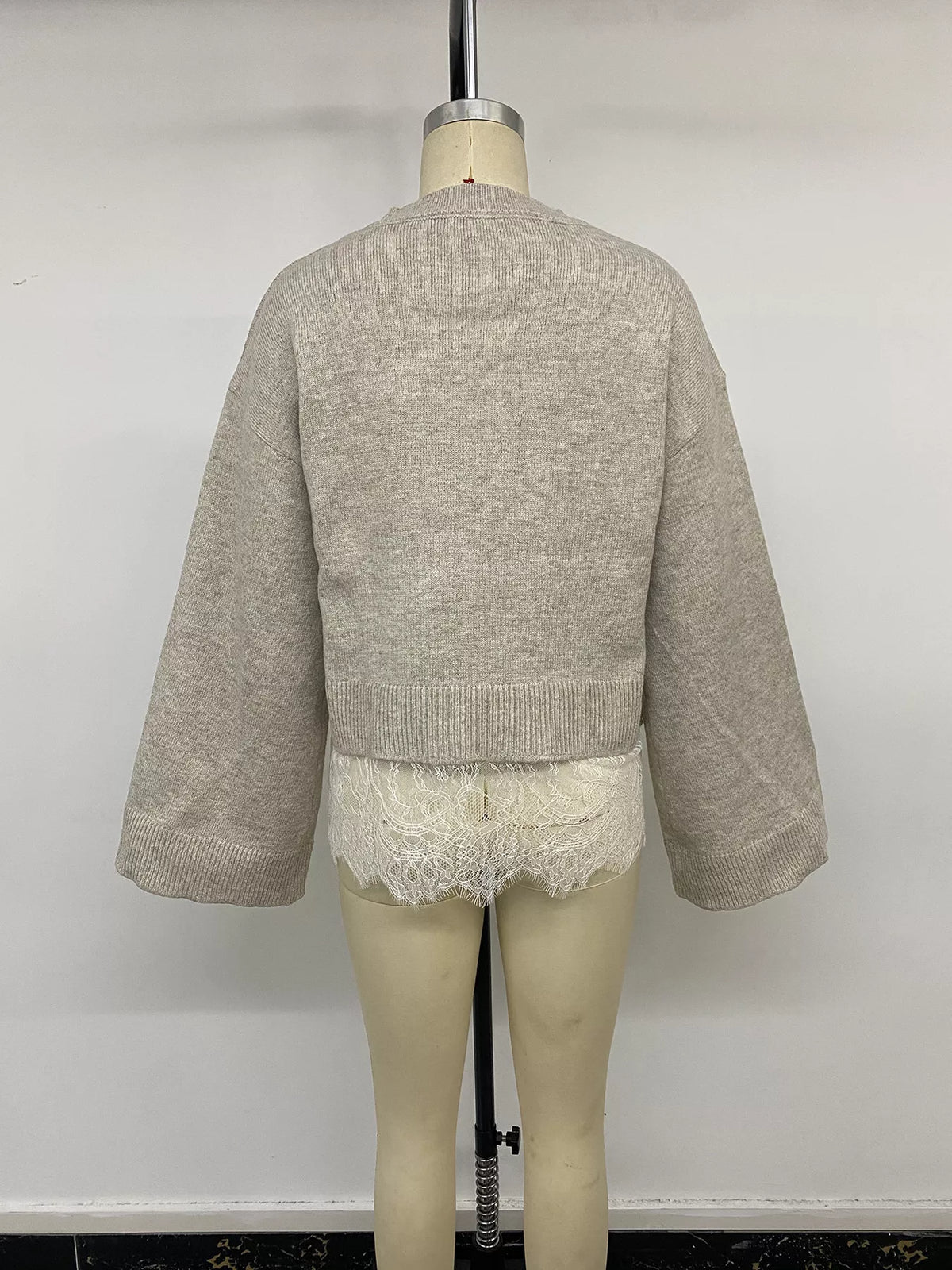 Beige layered lace hem sweater, back on mannequin