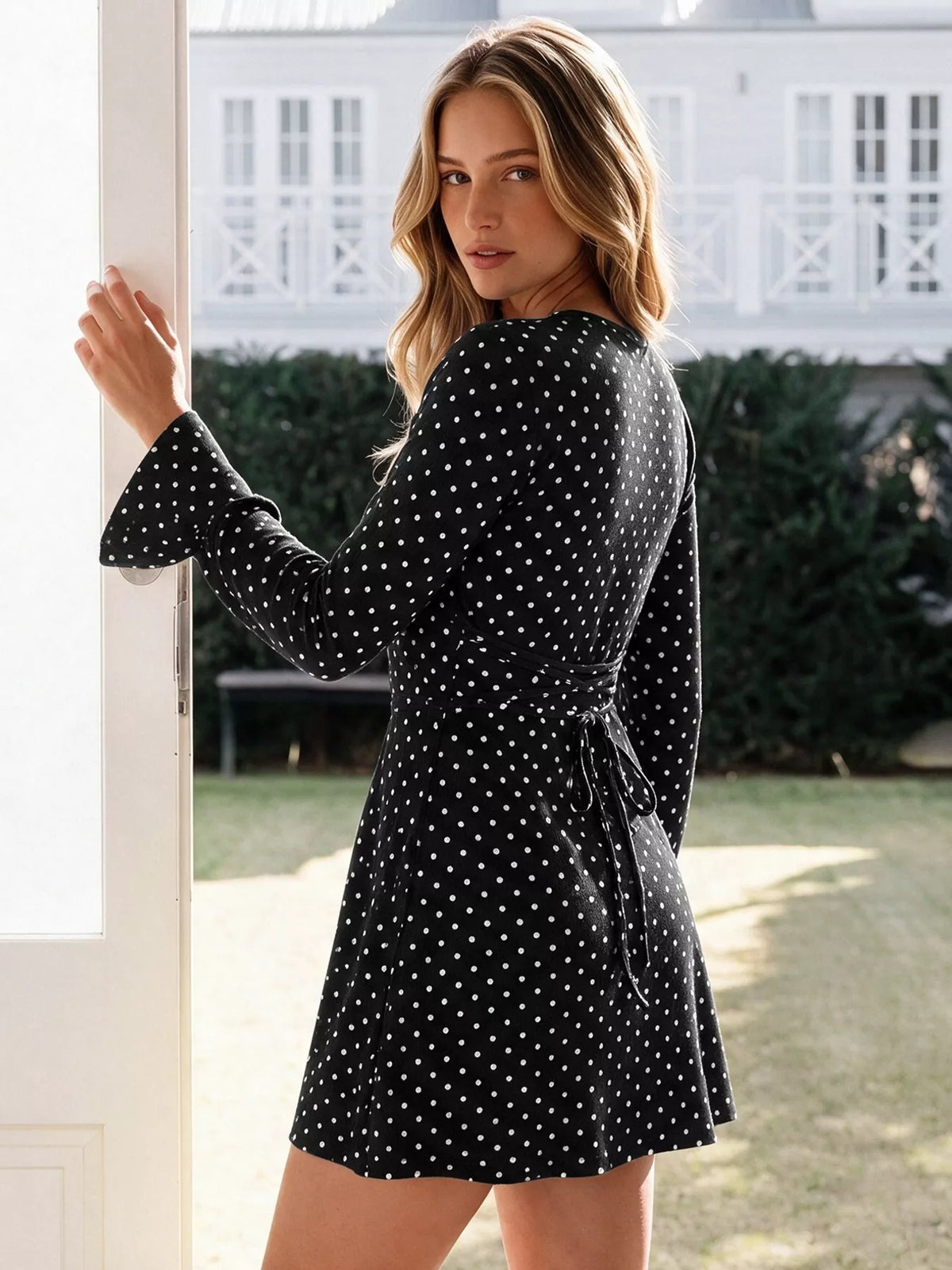 Black polka dot flounce sleeve mini dress, back view