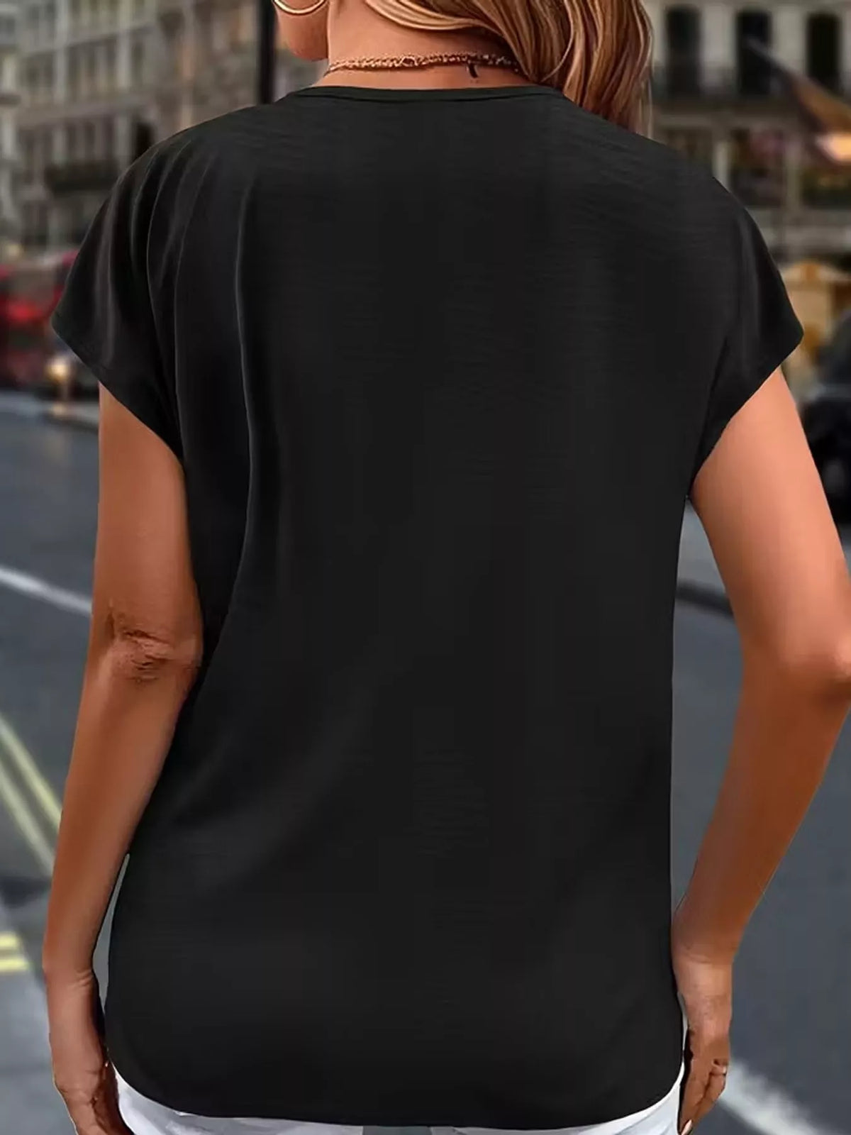 Black v-neck ruffle trim button-down shirt, back view