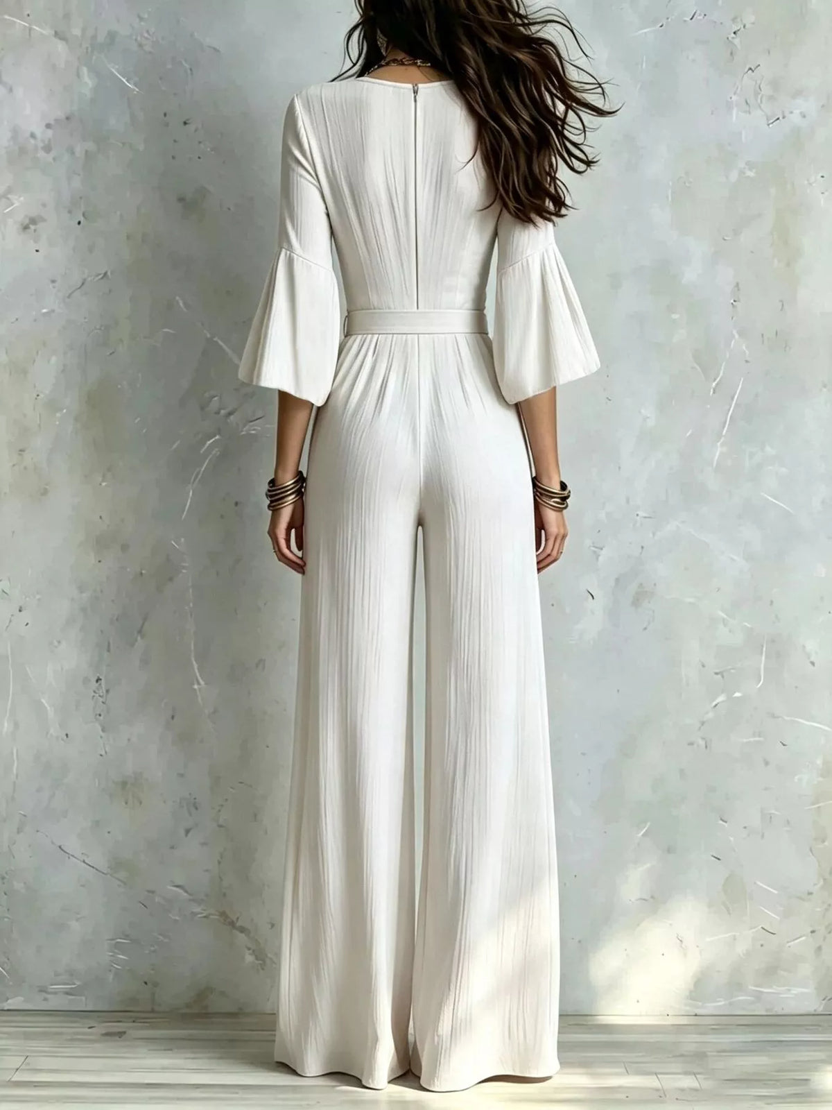 White pleated wide-leg jumpsuit with tie-waist, back view