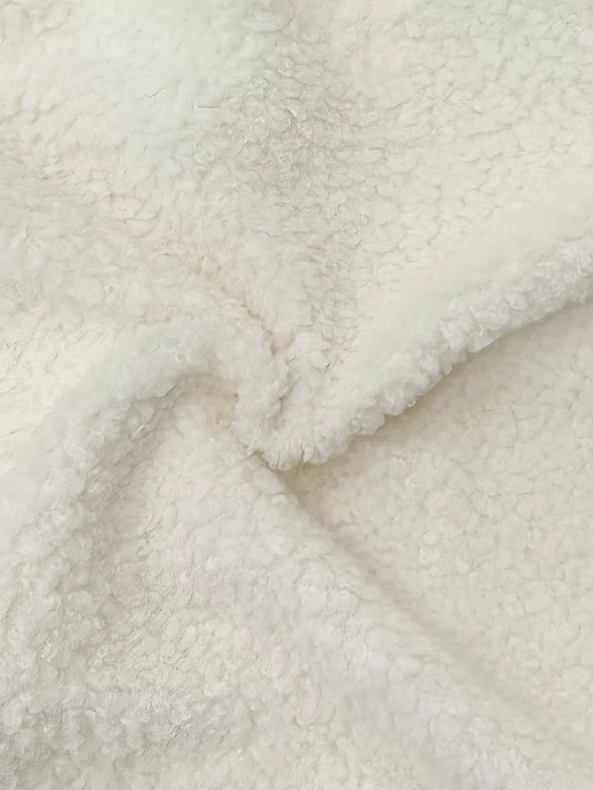 Cream with black trim faux shearling contrast trim button-down jacket, close-up of textured fabric