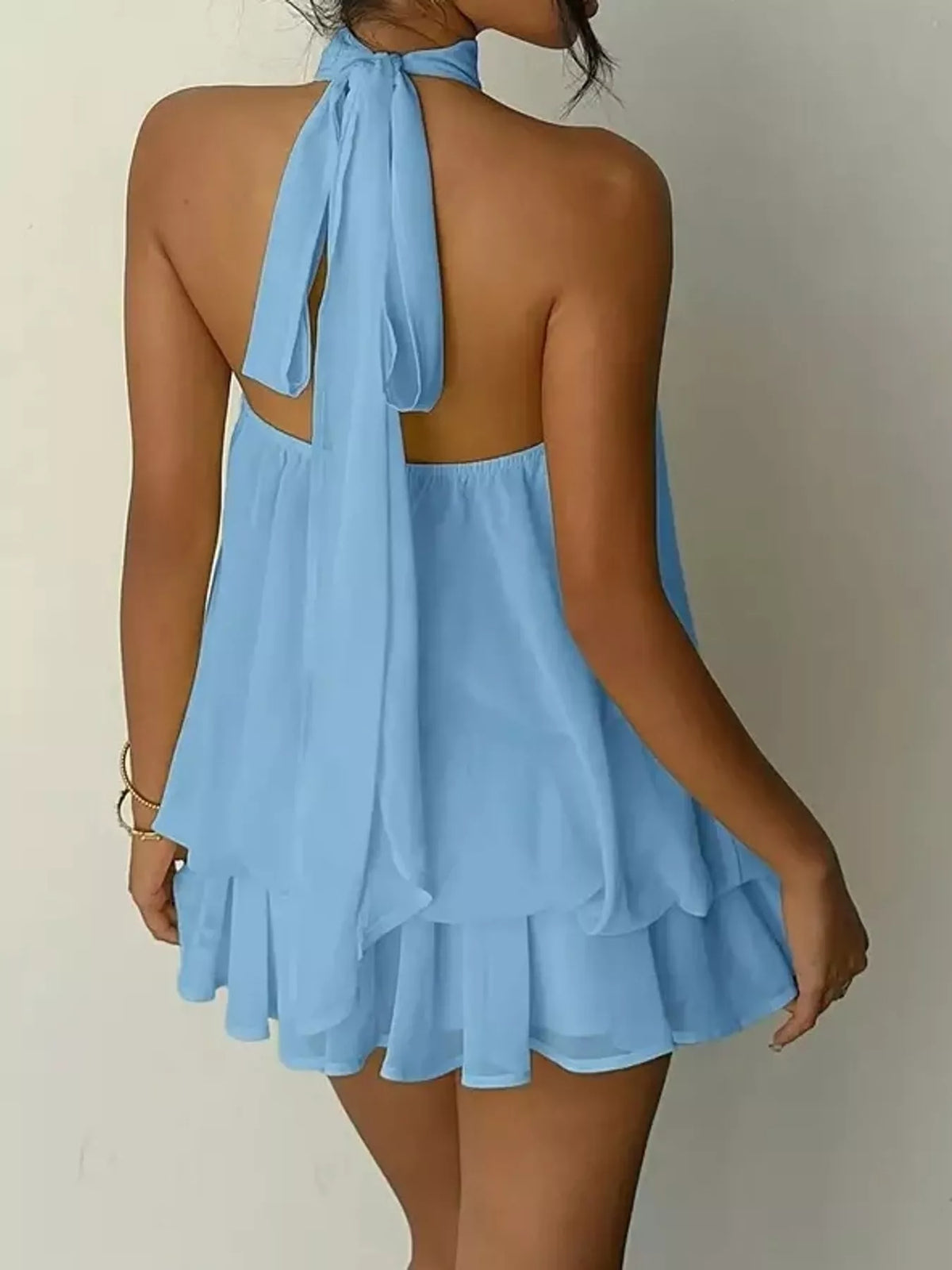 Blue halter neck layered mini dress, back tie view