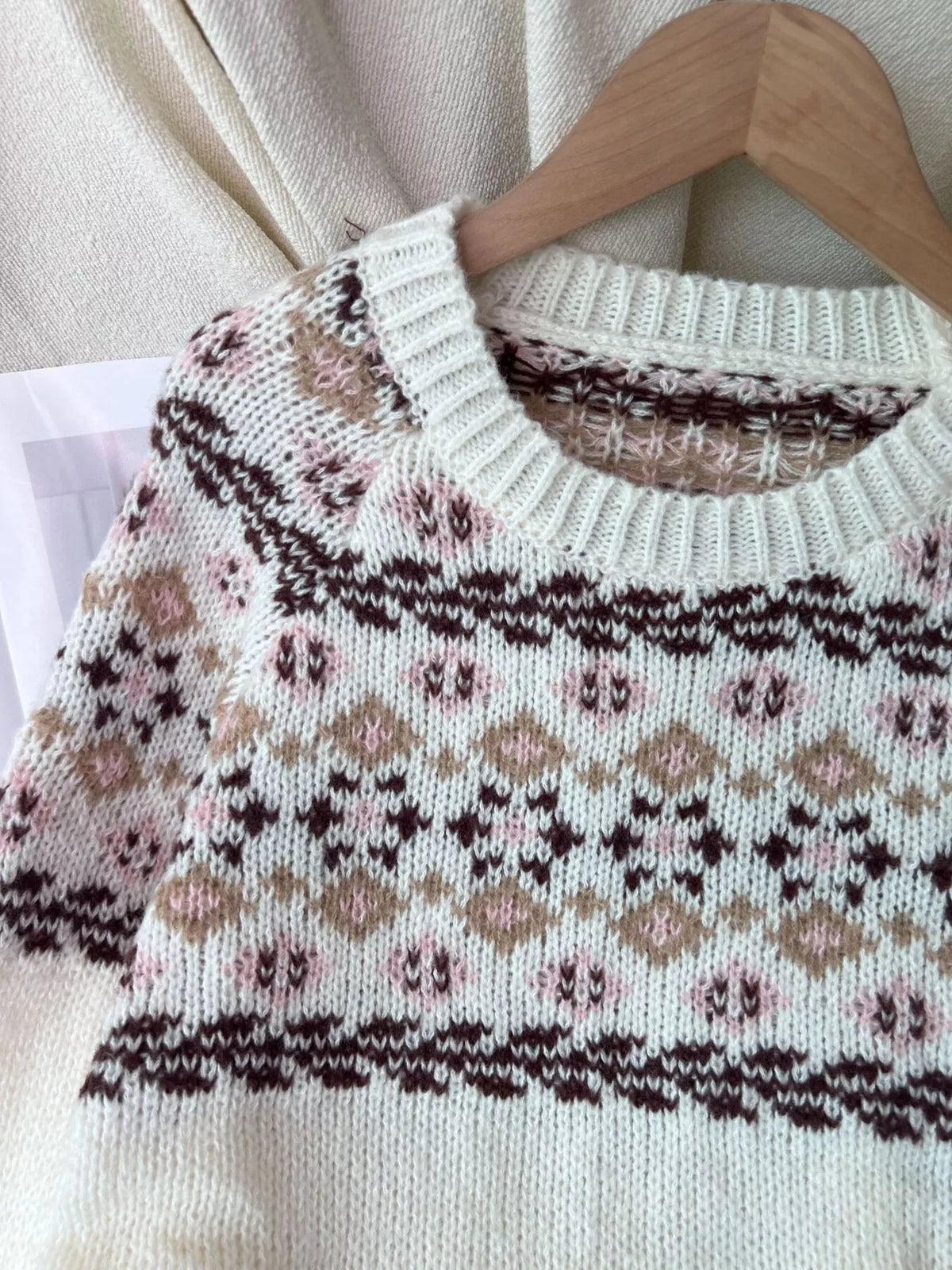 Cream fair isle round-neck sweater, neckline and Fair Isle pattern detail.