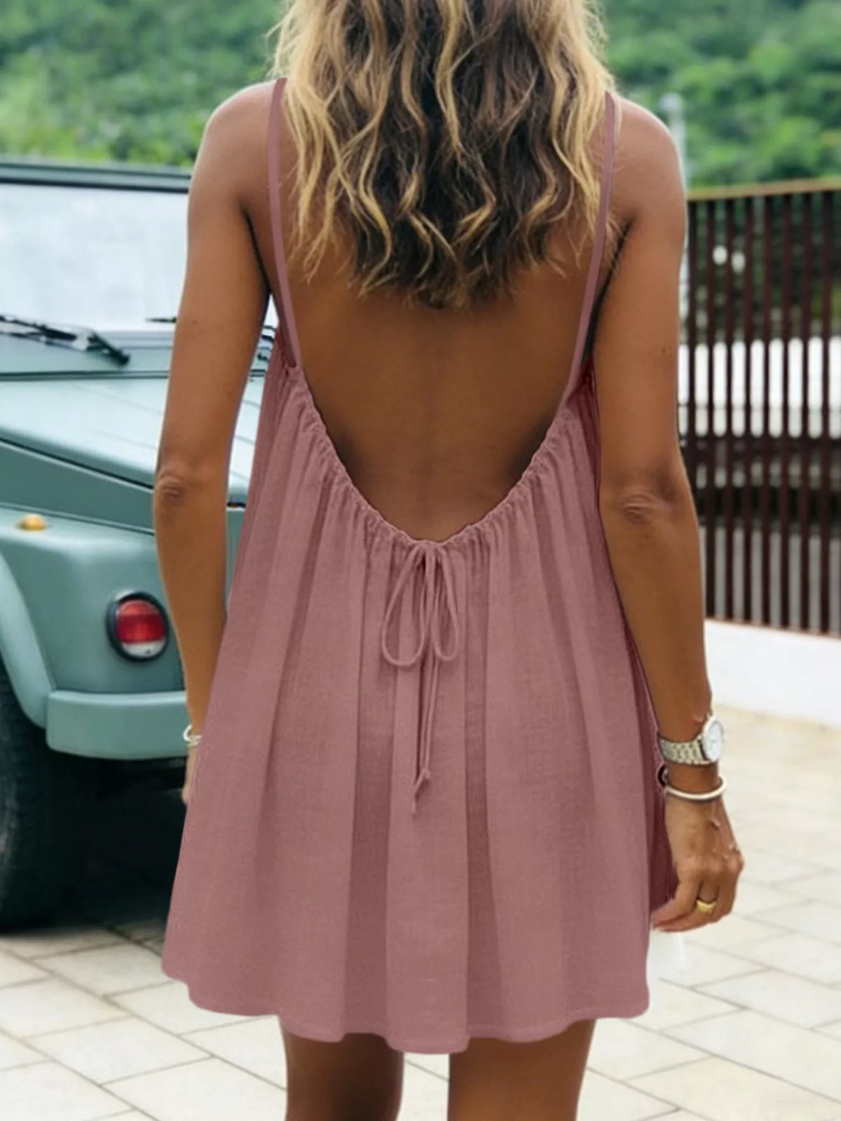 Dusty pink spaghetti strap A-line mini dress with open tie back, open back view