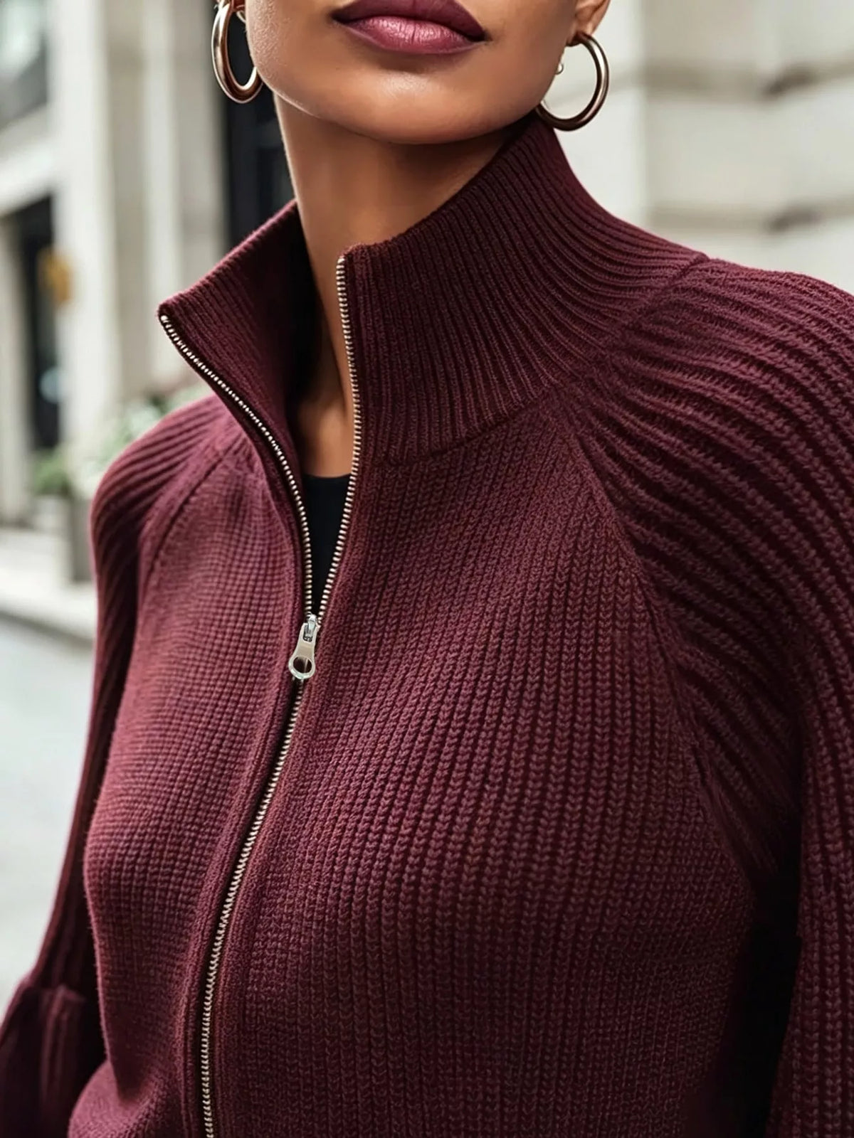 Burgundy ribbed knit zip-up cardigan with lantern sleeves, zip-up mock neckline and ribbed knit