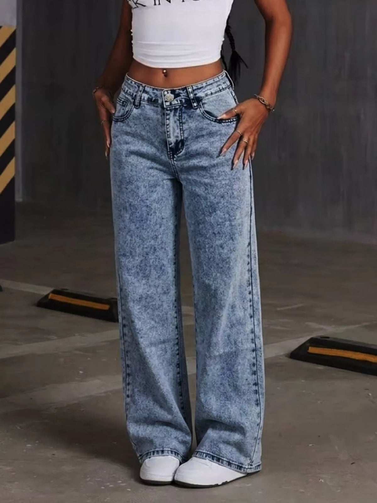 Blue bow-embroidered wide-leg jeans, full front view.